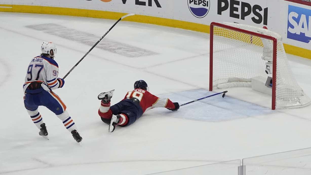 Florida Panthers left wing Matthew Tkachuk (19) attempts to stop a goal by Edmonton Oilers center Connor McDavid (97) during the third period of Game 5 of the NHL hockey Stanley Cup Finals, Tuesday, June 18, 2024, in Sunrise, Fla. The Oilers defeated the Panthers 5-3.