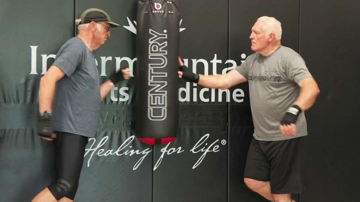 Tom Nehring practices his punches against a punching bag with another boxer recently in Ogden.