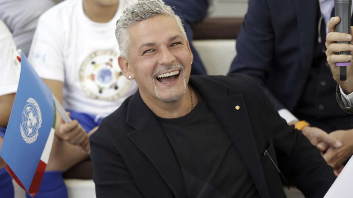 FILE - Italian soccer legend Roberto Baggio smiles as he attends an event at the Expo 2015 World's Fair on the occasion of the UN World Food Day in Rho, near Milan, Italy, Friday, Oct. 16, 2015. Retired Italy star Roberto Baggio was robbed at gunpoint on Thursday, June 20, 2024 at his home while watching the national team’s game against Spain at the European Championship. Italian media reports say at least five armed robbers burst into Baggio’s villa near the northern city of Vicenza around around 10 p.m.
