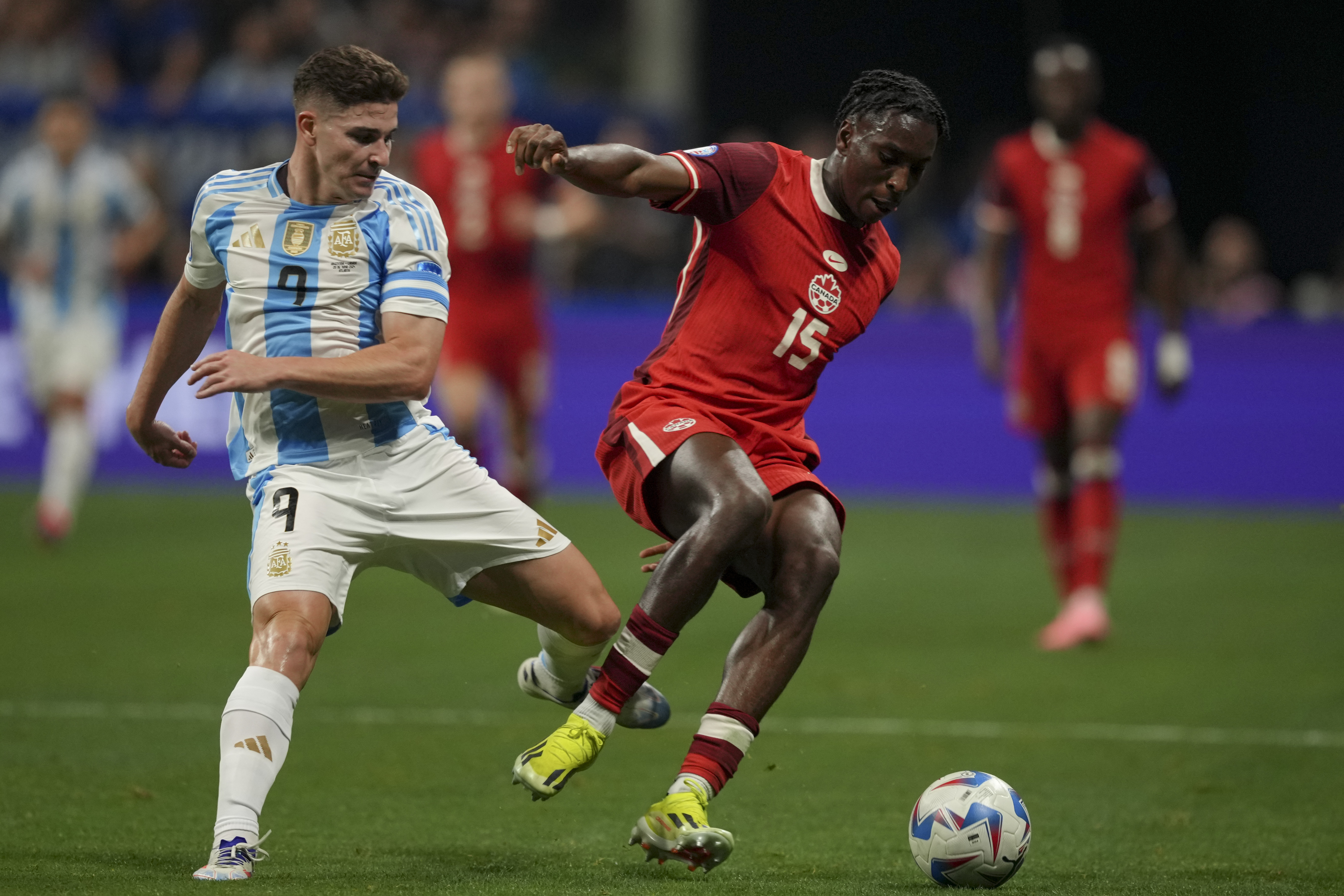 Argentina's Julian Alvarez, left, and Canada's Moise Bombito battle for the ball during a Copa America Group A soccer match in Atlanta, Thursday, June 20, 2024.