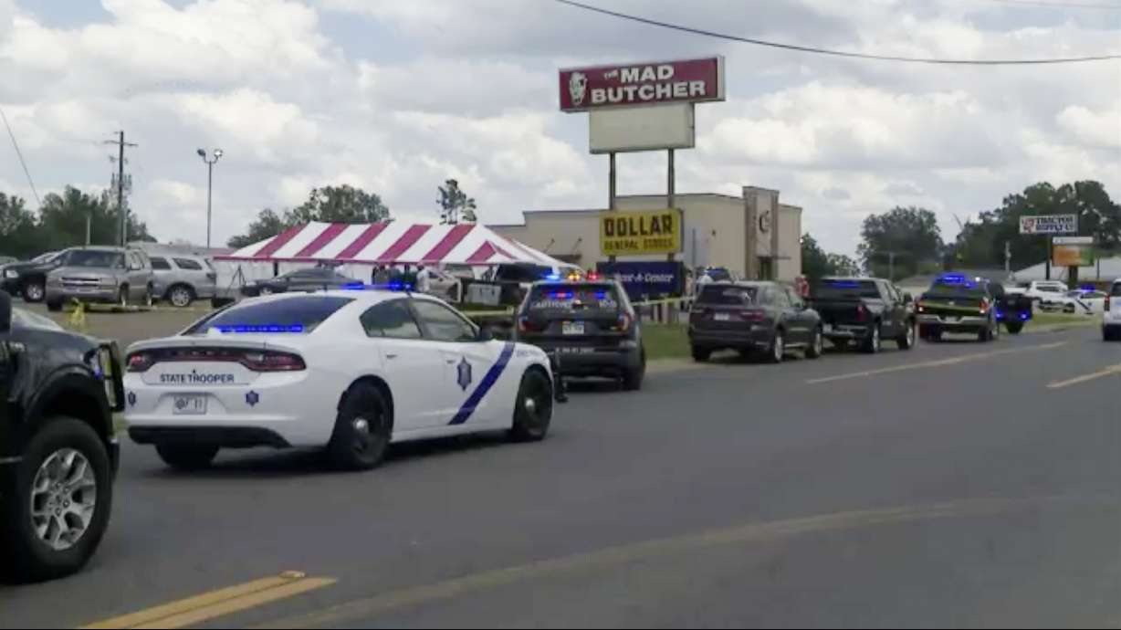 Police respond to the scene of a shooting on Friday in Fordyce, Ark. Arkansas State Police say three people were killed and 10 wounded in a shooting that occurred at a grocery store in south Arkansas.