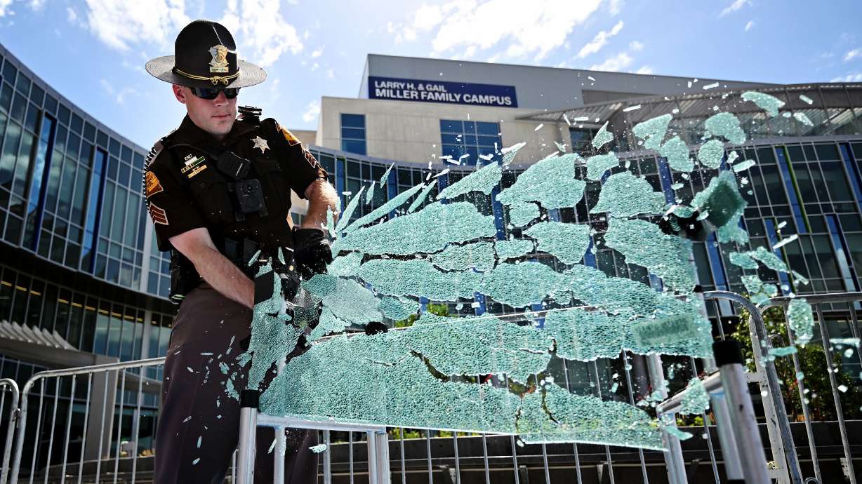 Utah Highway Patrol Sgt. Kristopher Cope uses a Resqme seat belt/window breaker during a demonstration with Intermountain Children’s Health and public safety experts, who warned Utahns to never leave children in a vehicle on Friday.