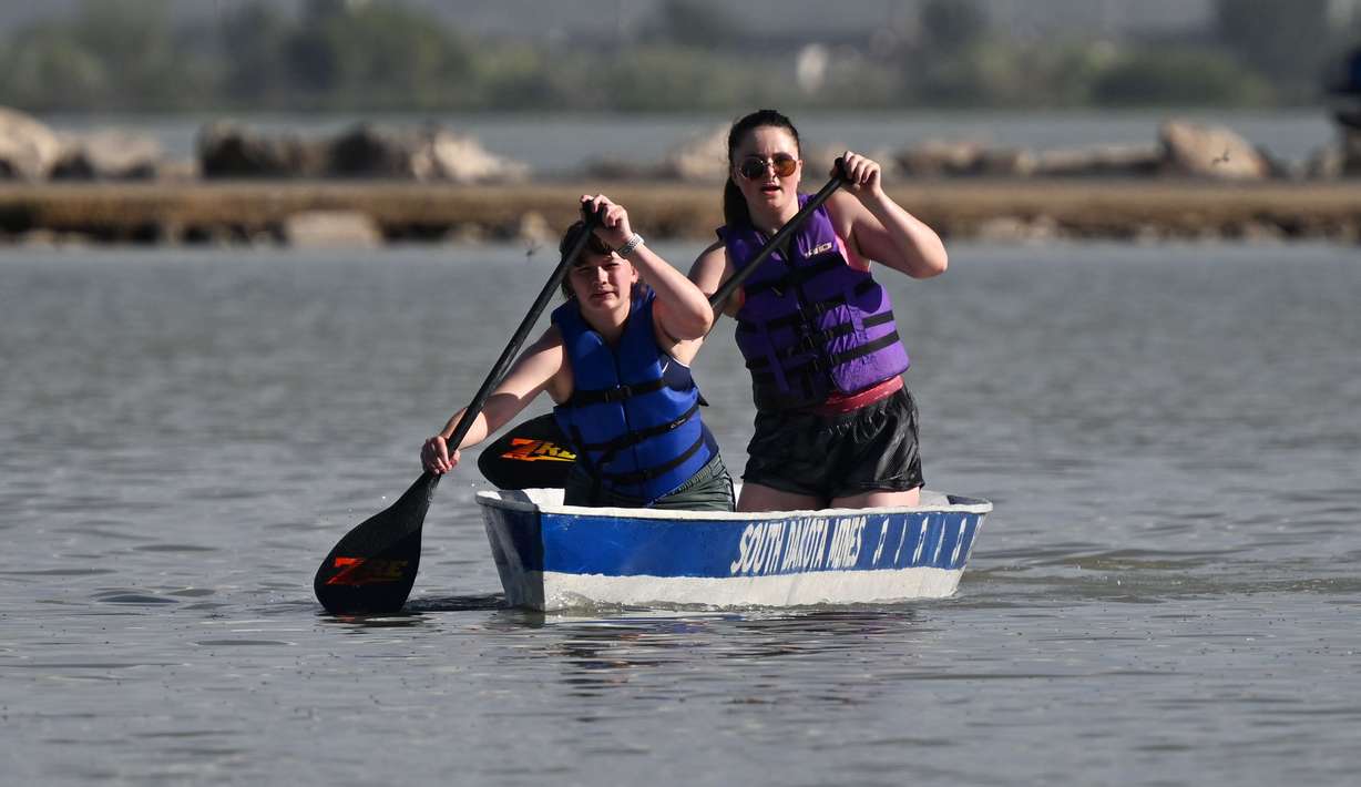 Ella Froning and teammate Elli Hollenbeck, South Dakota College Mines, battle toward the finish in their concrete canoe as they and other students from across the country compete in the ASCE Civil Engineering Student Championships at Utah Lake on Friday.