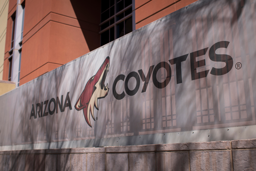 An Arizona Coyotes banner is pictured in Glendale, Arizona on March 21, 2021. Its owners said an Arizona department's decision Friday to cancel a land auction that was set for next week "seriously jeopardizes" the ability to rekindle the Coyotes after the original rendition team was sold and relocated to Utah this year.