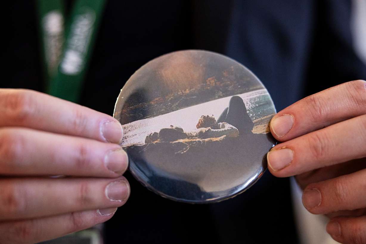 Evan Done, associate director of Utah Support Advocates for Recovery Awareness, holds a button showing a photograph from the 1970’s of his late mother, Ilene Done, at USARA’s offices in South Salt Lake on Thursday. Ilene passed away in 2011 from substance use disorder.