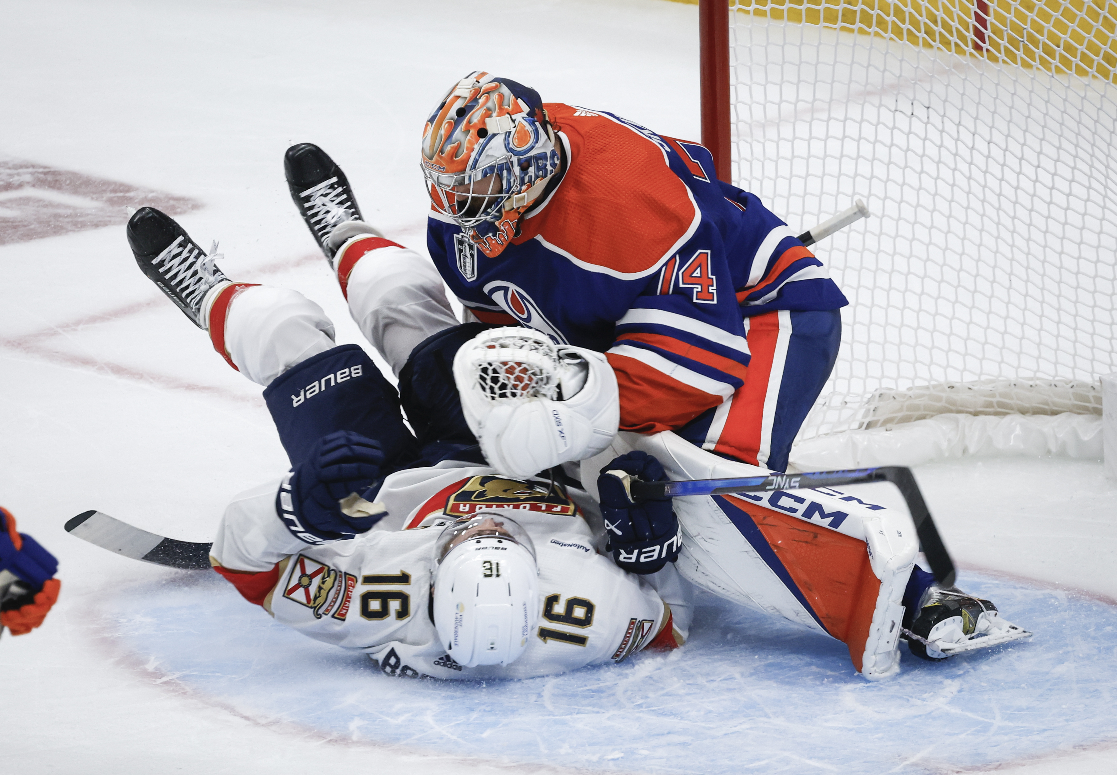 Florida Panthers' Aleksander Barkov (16) crashes into Edmonton Oilers goalie Stuart Skinner (74) during the second period of Game 6 of the NHL hockey Stanley Cup Final, Friday, June 21, 2024, in Edmonton, Alberta. 