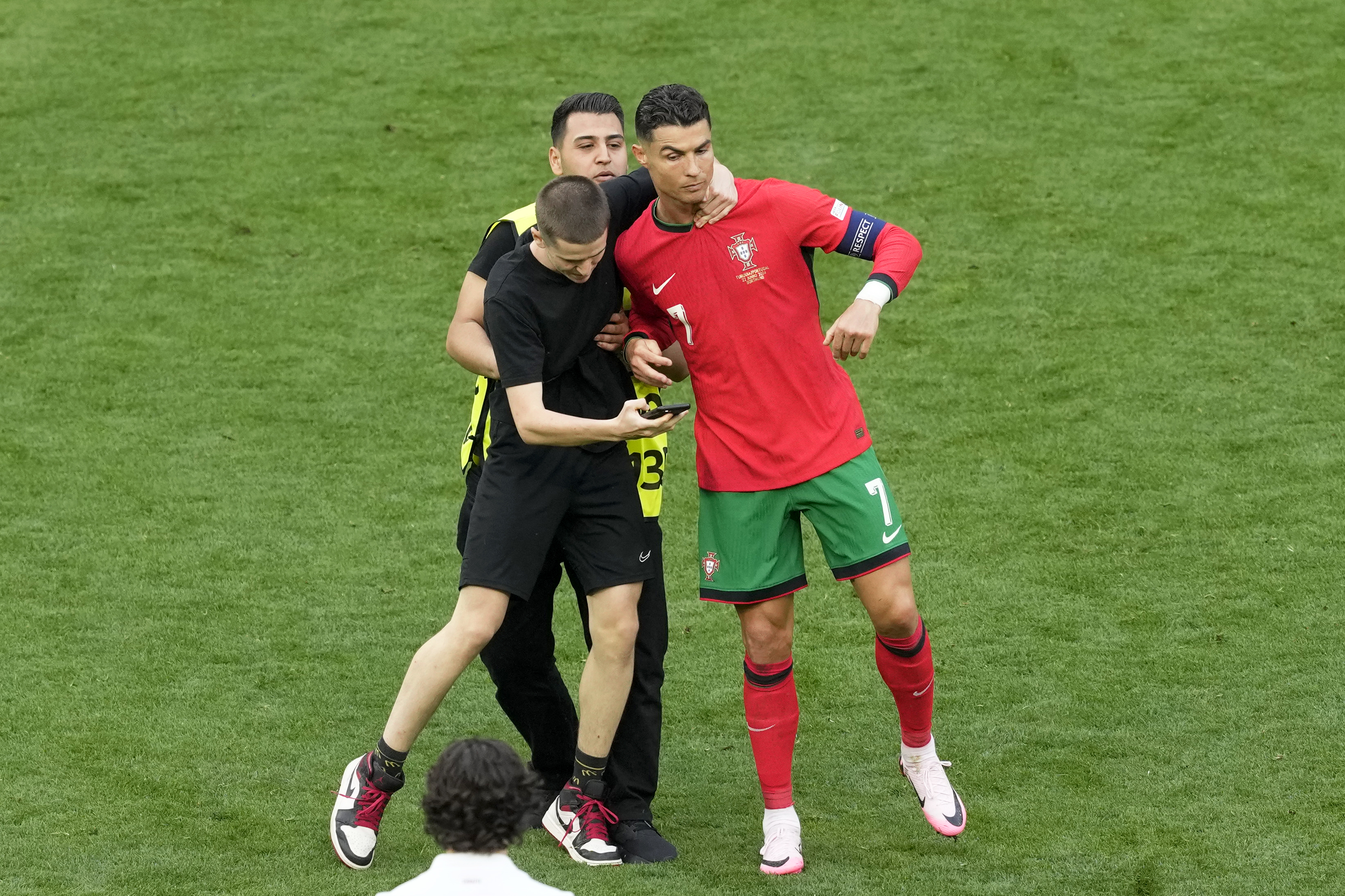 A pitch holds on to Portugal's Cristiano Ronaldo during a Group F match between Turkey and Portugal at the Euro 2024 soccer tournament in Dortmund, Germany, Saturday, June 22, 2024. 