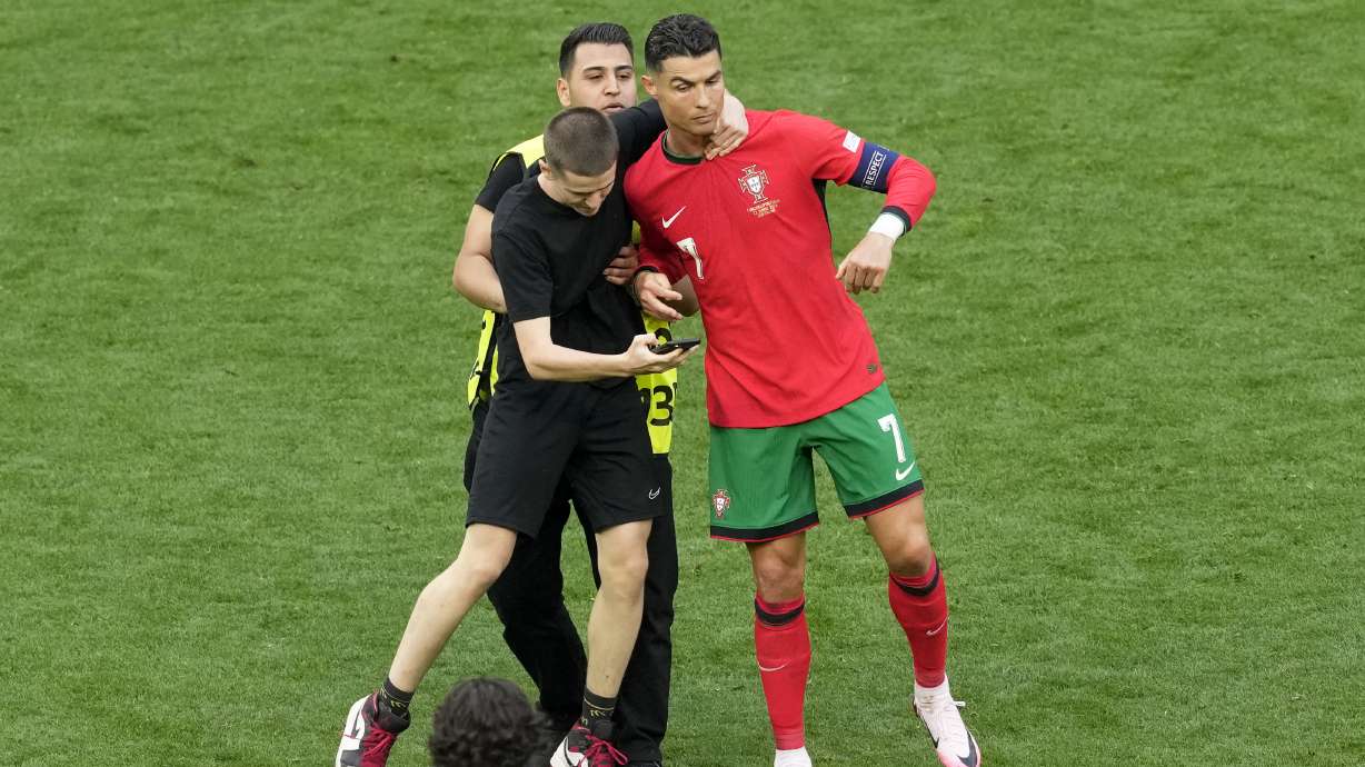 A pitch holds on to Portugal's Cristiano Ronaldo during a Group F match between Turkey and Portugal at the Euro 2024 soccer tournament in Dortmund, Germany, Saturday, June 22, 2024.