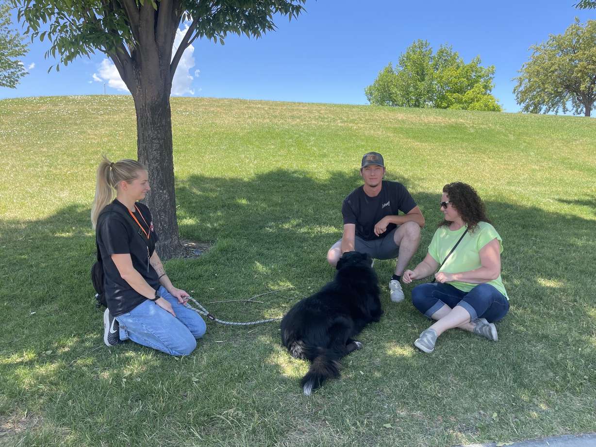 Krystal Arnett, left, helps introduce Jake and Jenni Varney to a dog. West Valley City Animal Services held a Shelter Saturday event, where people could come to adopt pets in need of a good home.