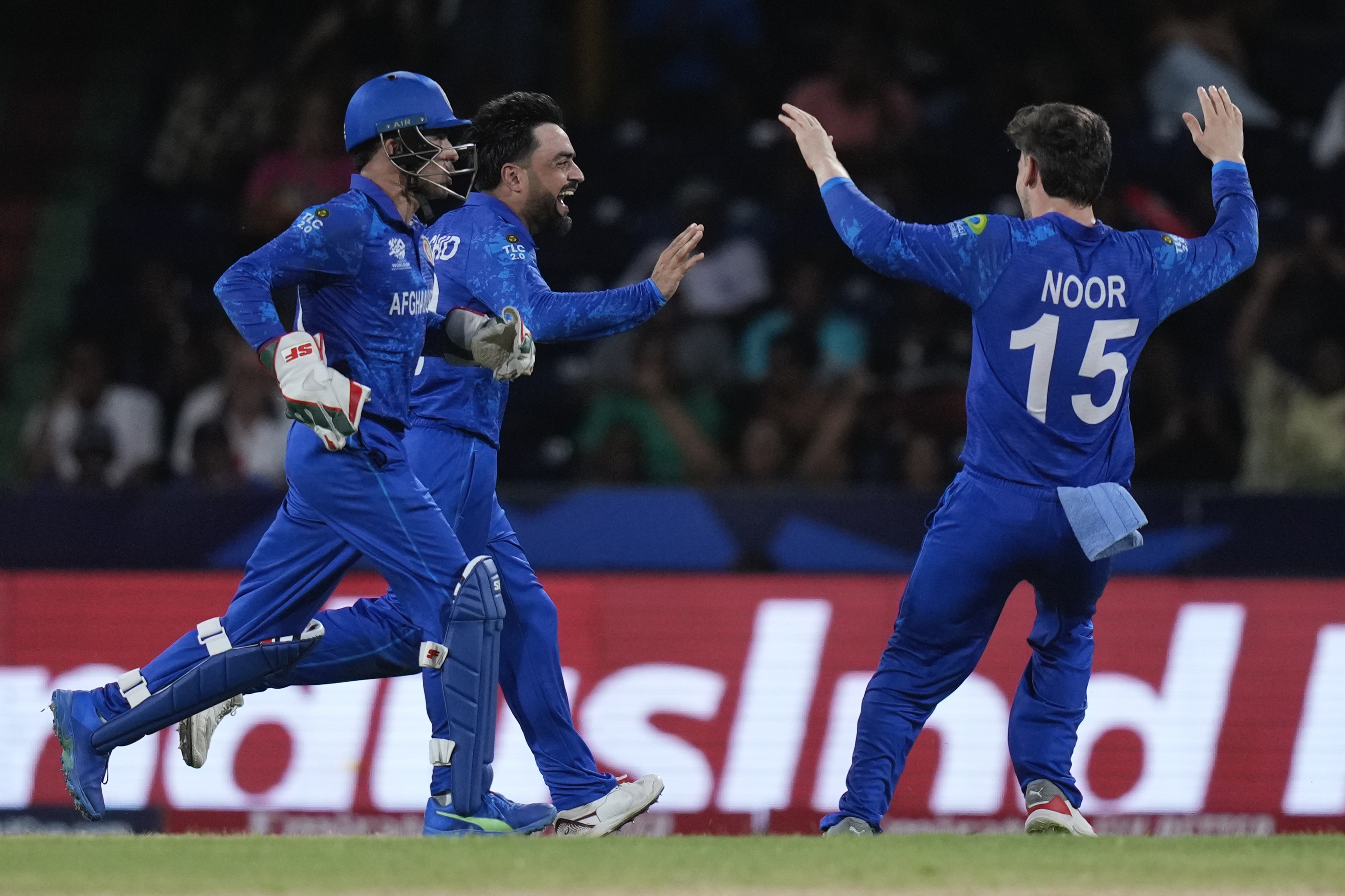 Afghanistan's captain Rashid Khan, centre, celebrates the wicket of Australia's Matthew Wade during the men's T20 World Cup cricket match between Afghanistan and Australia at Arnos Vale Ground, Kingstown, Saint Vincent and the Grenadines, Saturday, June 22, 2024. 