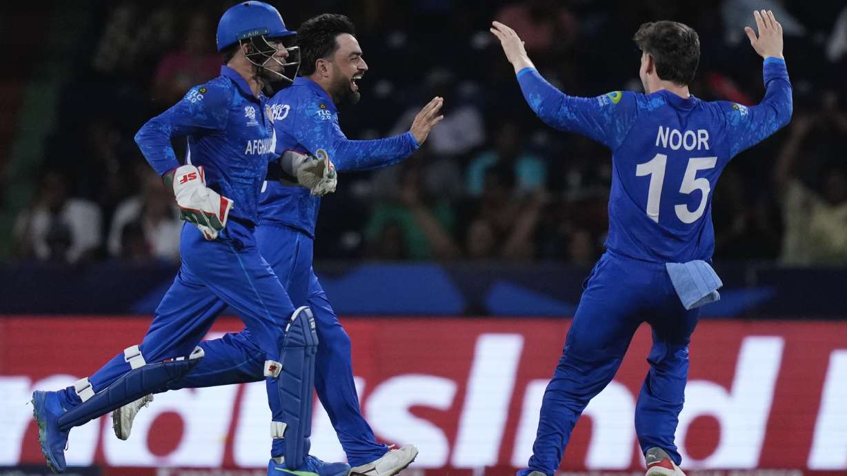 Afghanistan's captain Rashid Khan, centre, celebrates the wicket of Australia's Matthew Wade during the men's T20 World Cup cricket match between Afghanistan and Australia at Arnos Vale Ground, Kingstown, Saint Vincent and the Grenadines, Saturday, June 22, 2024.