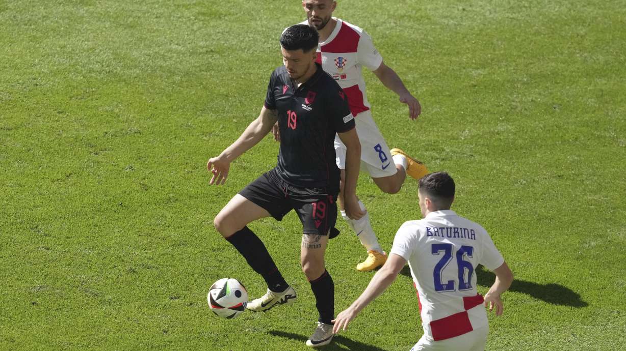 Albania's Mirlind Daku, centre, controls the ball ahead Croatia's Martin Baturina during a Group B match between Croatia and Albania at the Euro 2024 soccer tournament in Hamburg, Germany, Wednesday, June 19, 2024.