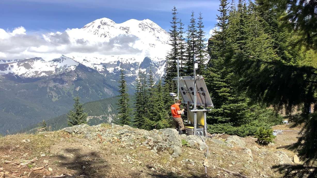 USGS Cascades Volcano Observatory geophysicist Rebecca Kramer works on station PR05, part of the Mount Rainier lahar detection network. The system has been upgraded and expanded since it was first set up in 1998.