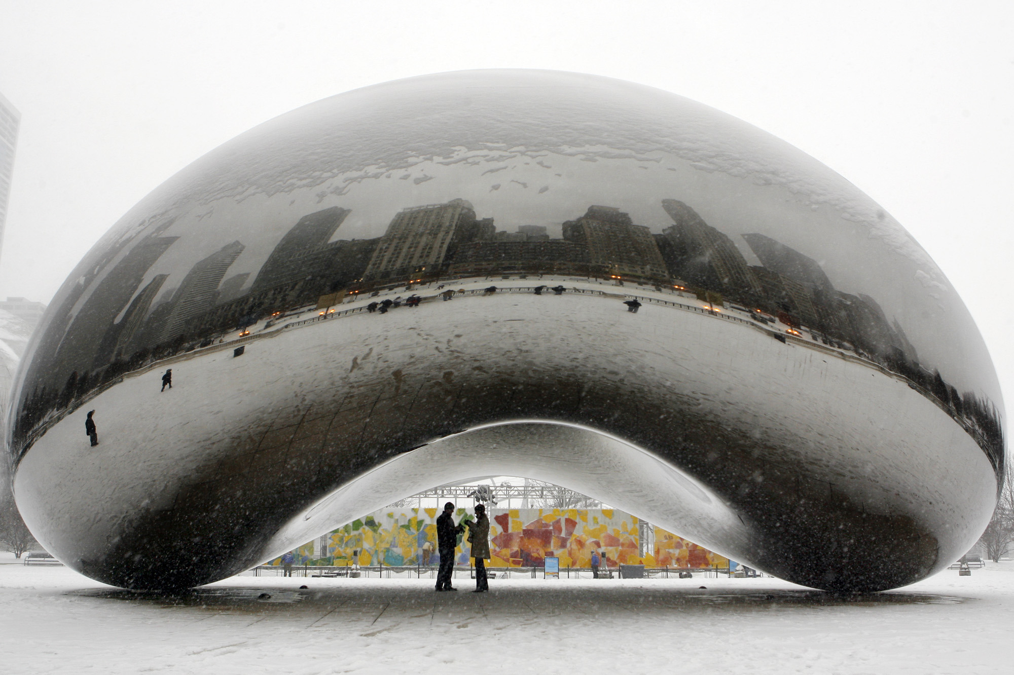 On Jan. 31, 2008, a couple is seen on the underside of the 110-ton stainless steel Anish Kapoor sculpture called "Cloud Gate" and nicknamed "The Bean" at Millennium Park in Chicago. The attraction has reopened after nearly a year of construction.