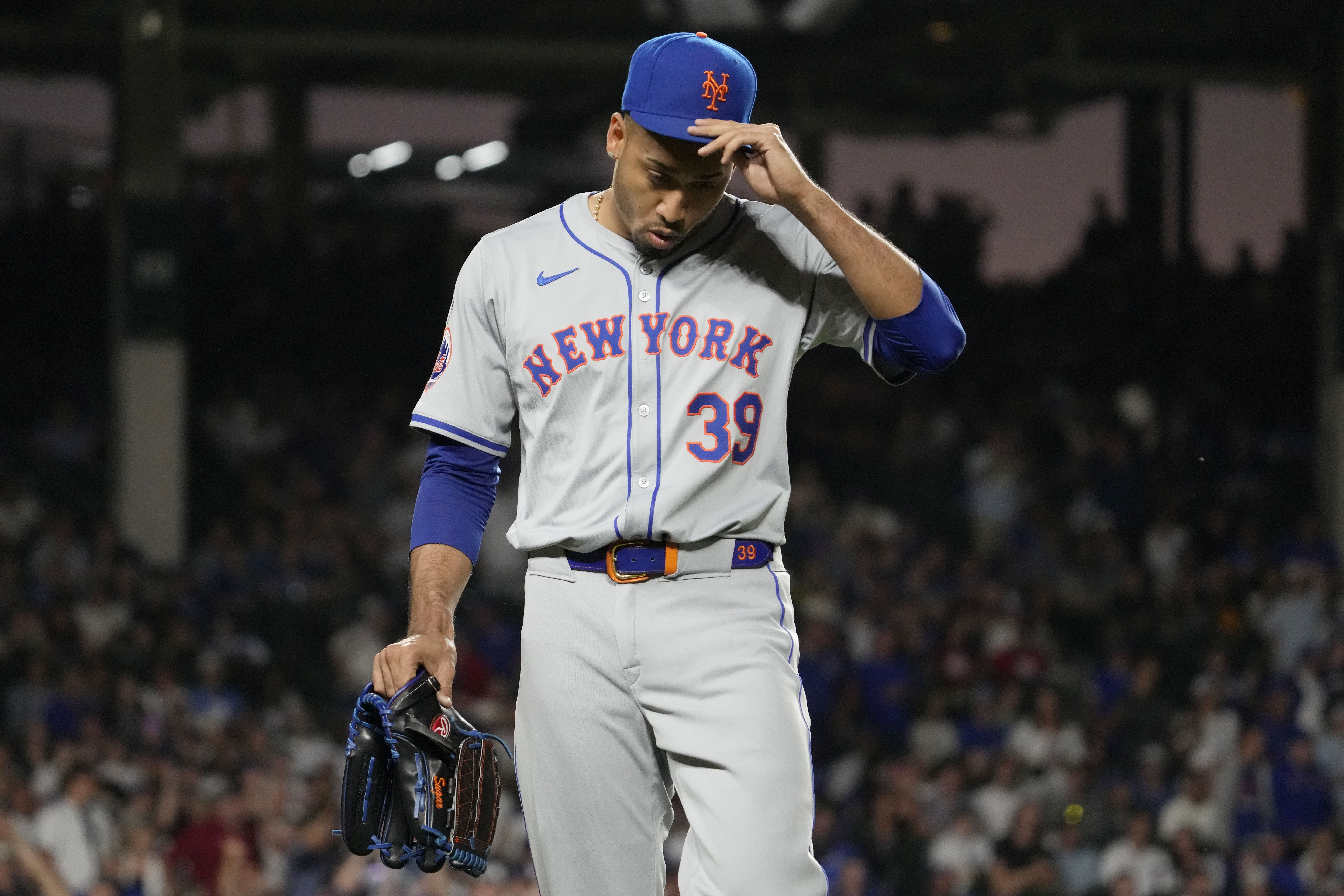 New York Mets relief pitcher Edwin Díaz reacts after being ejected by their base umpire Vic Carapazza during the ninth inning of a baseball game against the Chicago Cubs in Chicago, Sunday, June 23, 2024. 
