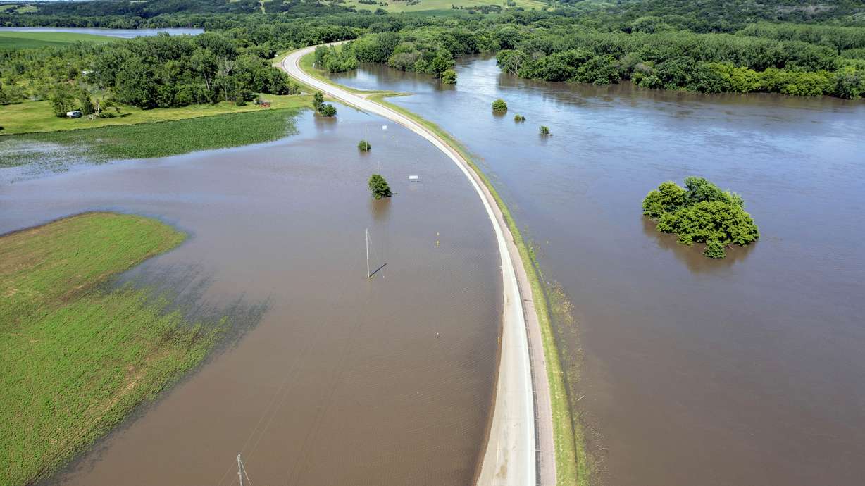 Highway 18 is underwater after days of heavy rain led to flooding in the area, Saturday, in Canton, S.D.