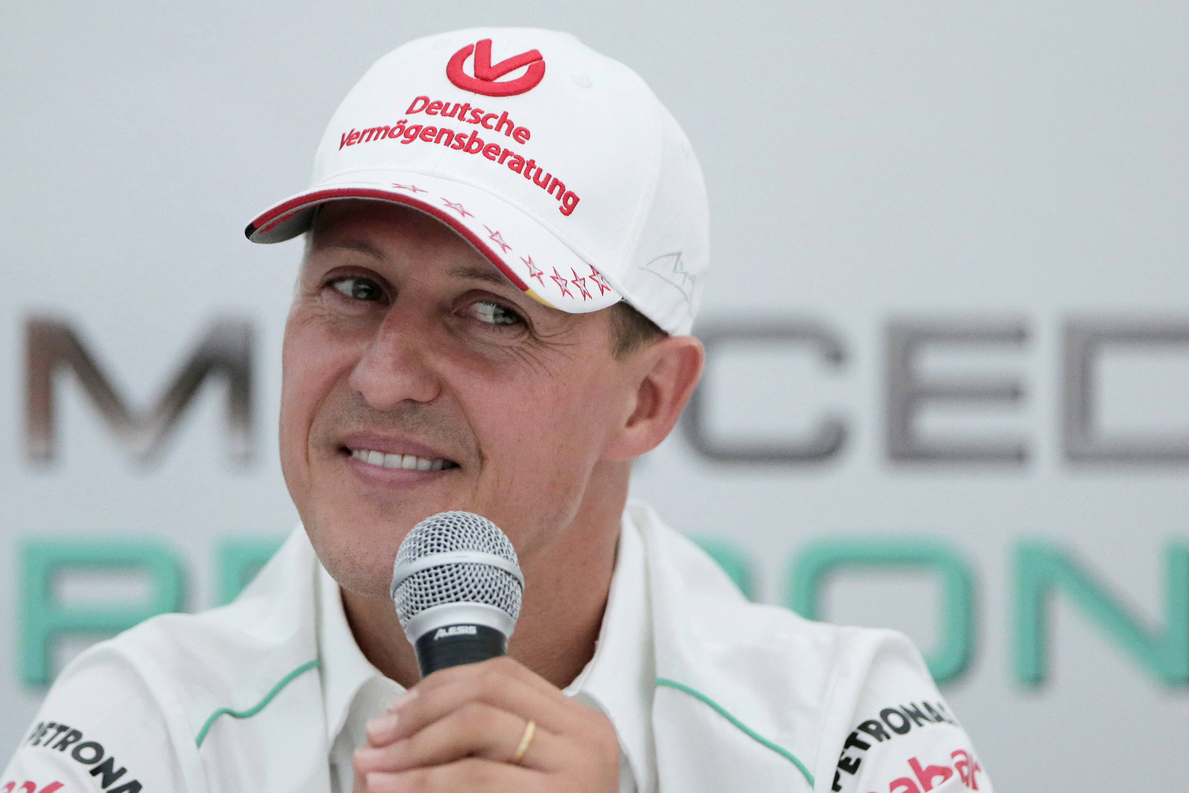 FILE - Michael Schumacher announces his retirement from Formula One during a press conference at the Suzuka Circuit venue for the Japanese Formula One Grand Prix in Suzuka, Japan, Oct. 4, 2012. German prosecutors say two men who allegedly tried blackmailing the family of former Formula 1 champion Michael Schumacher were detained earlier this month. Prosecutors in the western German city of Wuppertal said Monday the suspects told employees of the family that they were in possession of files that the family would not want to be published.