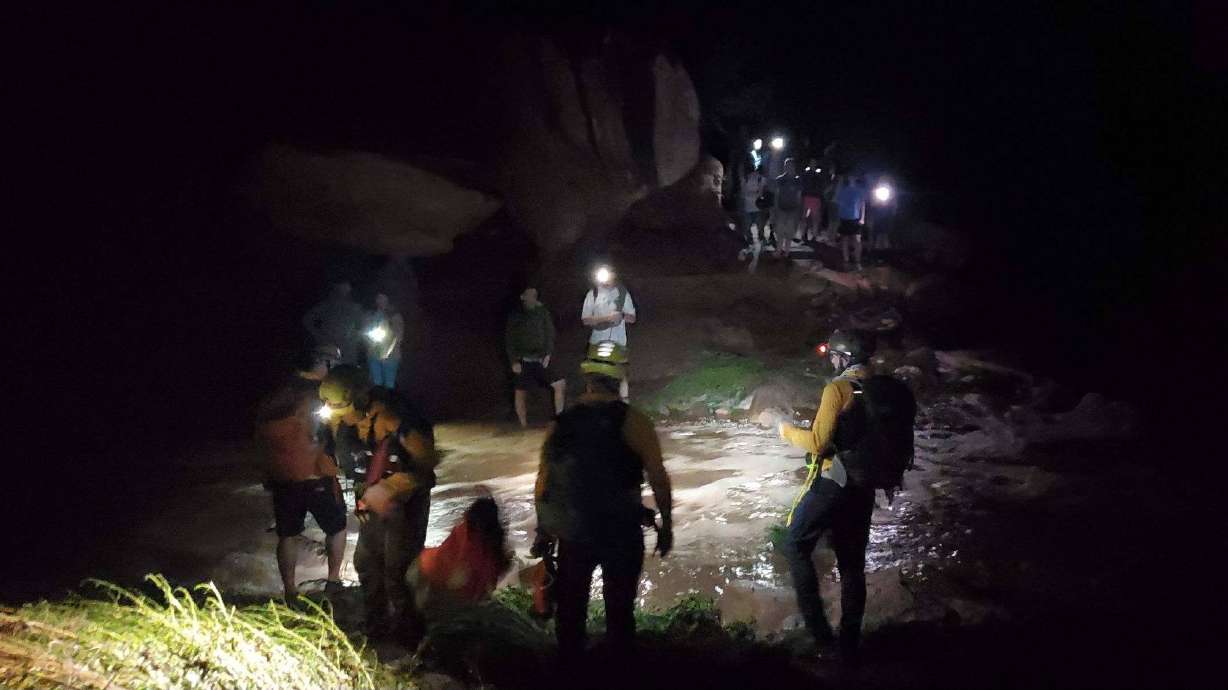 Grand County sheriff's search and rescue teams help 20 stranded hikers down from Grandstaff Canyon just outside of Moab on Friday. Flash flooding wreaked havoc in the region over the weekend.