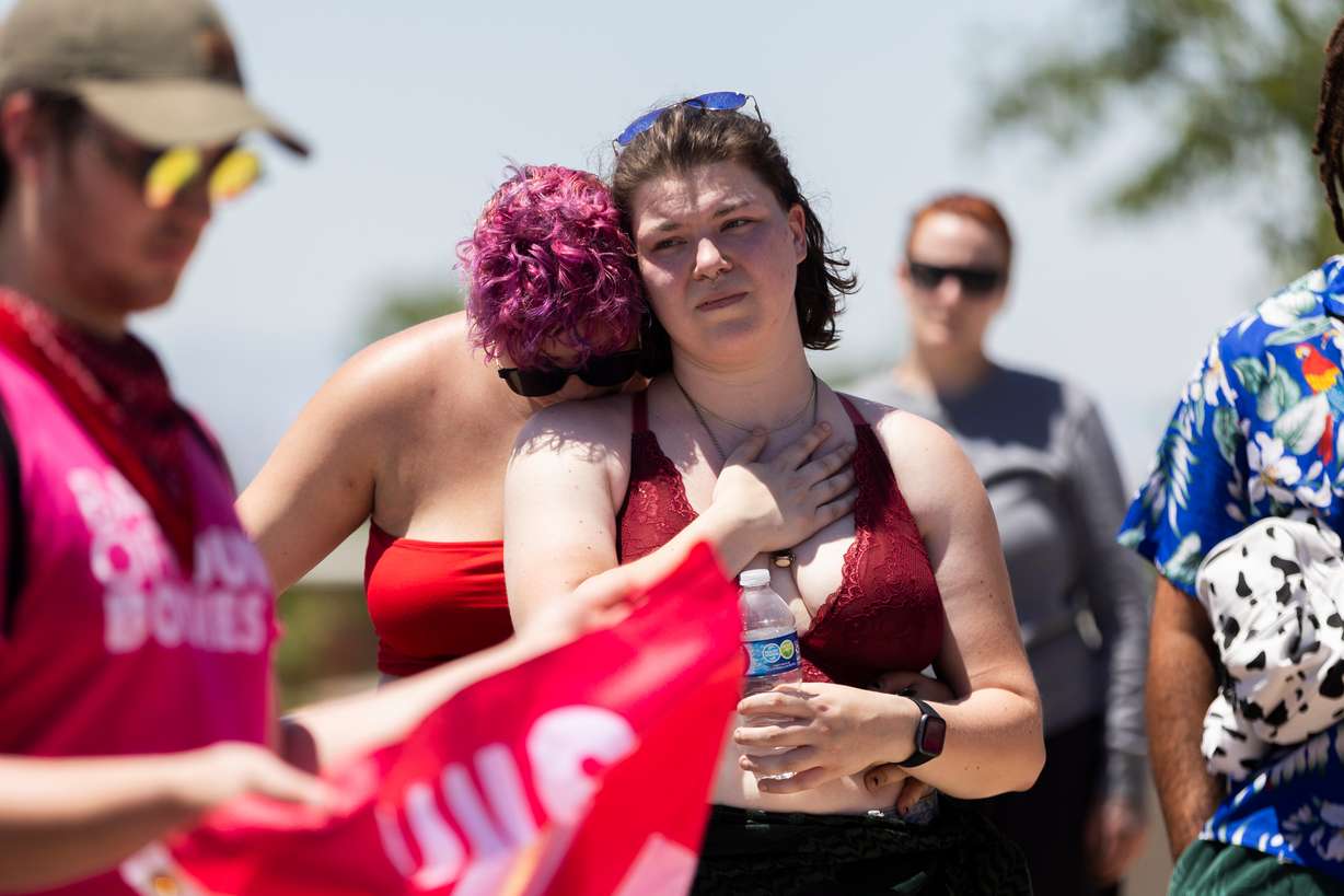 Izzy and Peggy, who prefer not to give their last names, lean on each other while listening to speakers during a protest of the two-year anniversary of the overturning of Roe v. Wade at the Capitol in Salt Lake City on Monday.