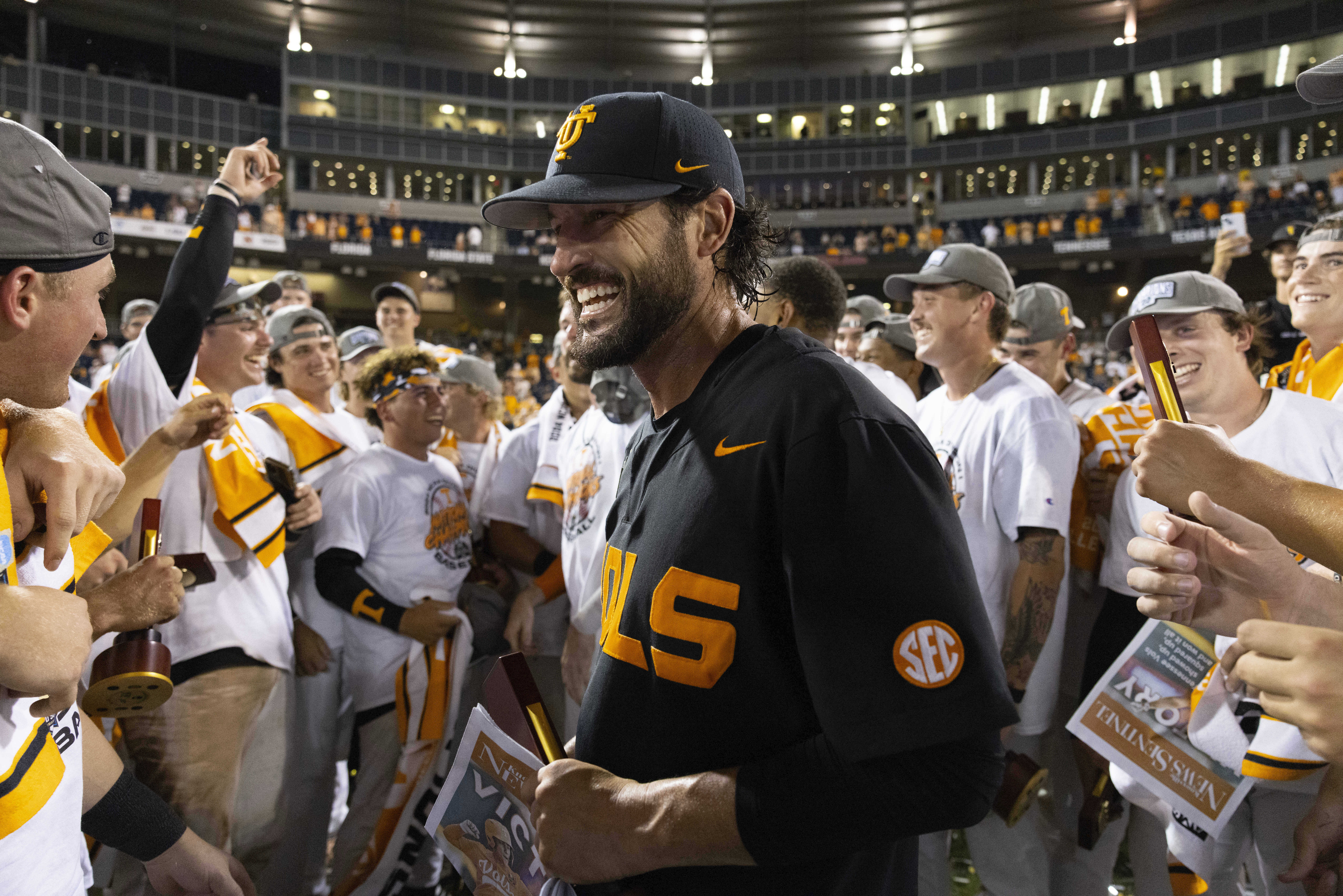 Tennessee coach Tony Vitello, center, celebrates with his team following their victory over Texas A&M in Game 3 of the NCAA College World Series baseball finals in Omaha, Neb., Monday, June 24, 2024. 