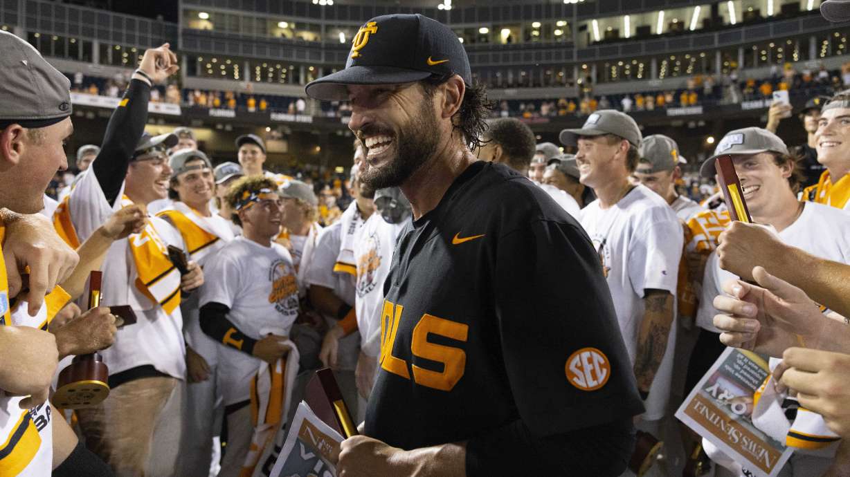 Tennessee coach Tony Vitello, center, celebrates with his team following their victory over Texas A&M in Game 3 of the NCAA College World Series baseball finals in Omaha, Neb., Monday, June 24, 2024.