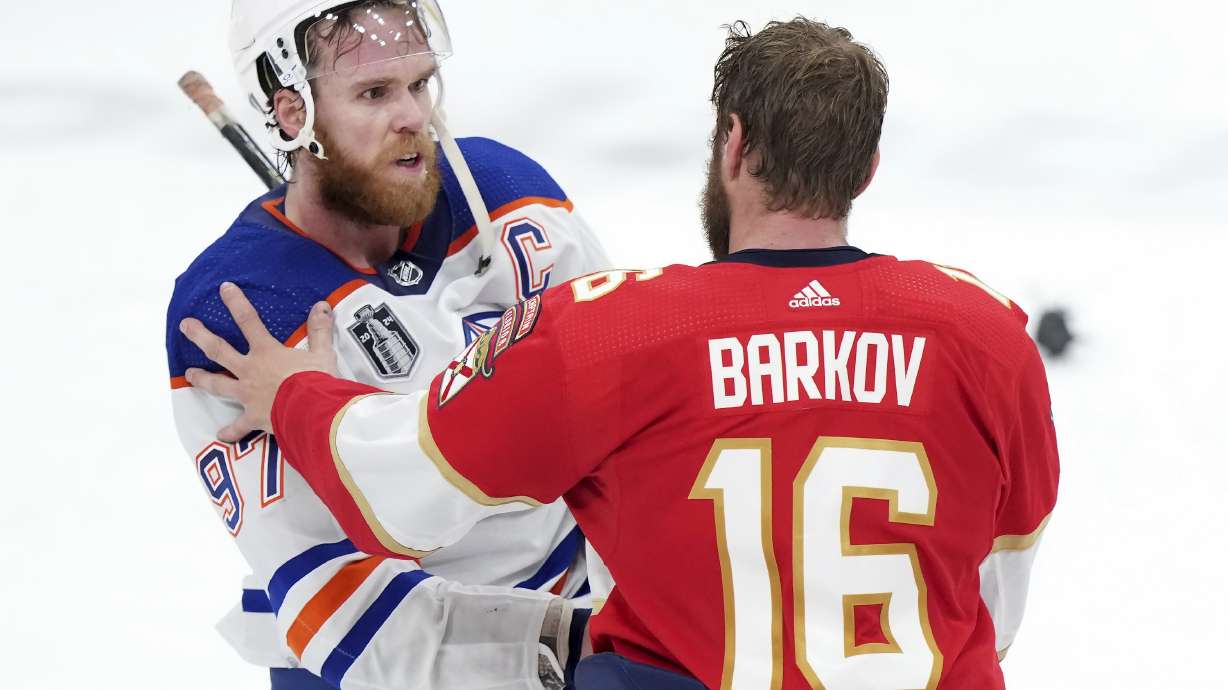 Edmonton Oilers forward Connor McDavid (97) congratulates Florida Panthers forward Aleksander Barkov (16) after Florida won Game 7 of the NHL hockey Stanley Cup Final in Sunrise, Fla., Monday, June 24, 2024.