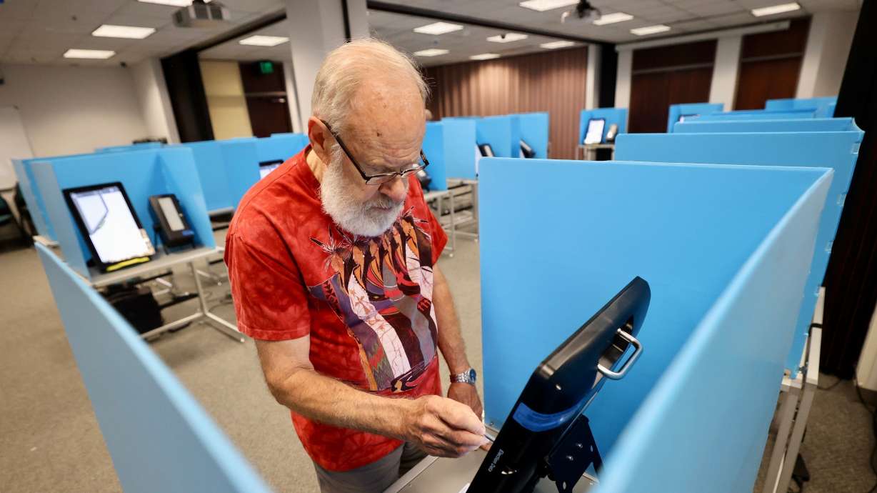 Terry Swanson casts his vote Tuesday in the primary elections, Tuesday at the Salt Lake County Government Center in Salt Lake City. Primary election day is Tuesday.
