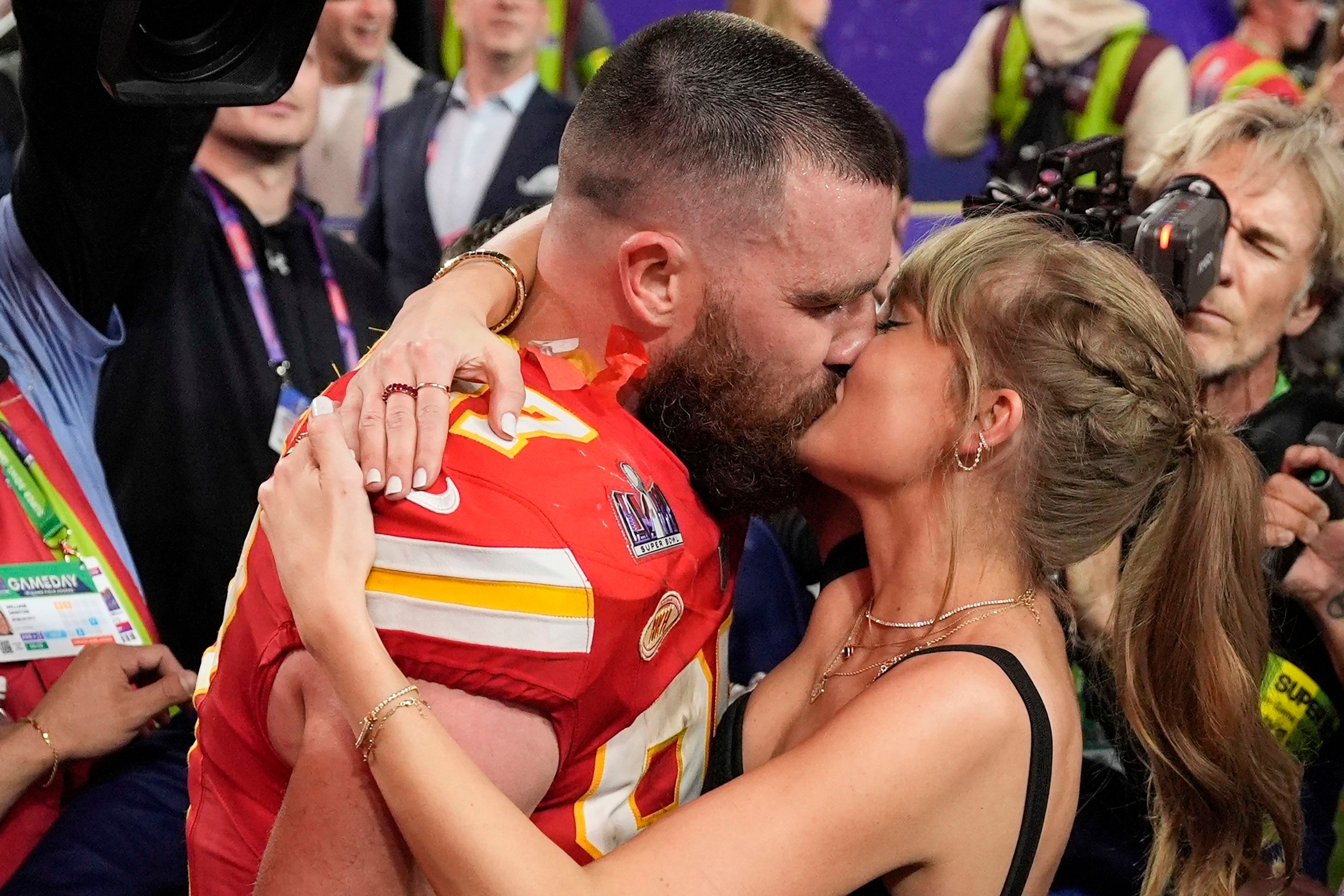 Travis Kelce kisses Taylor Swift on the field at Arrowhead Stadium after the Kansas City Chiefs beat the San Fransisco 49ers in the 2024 Super Bowl.