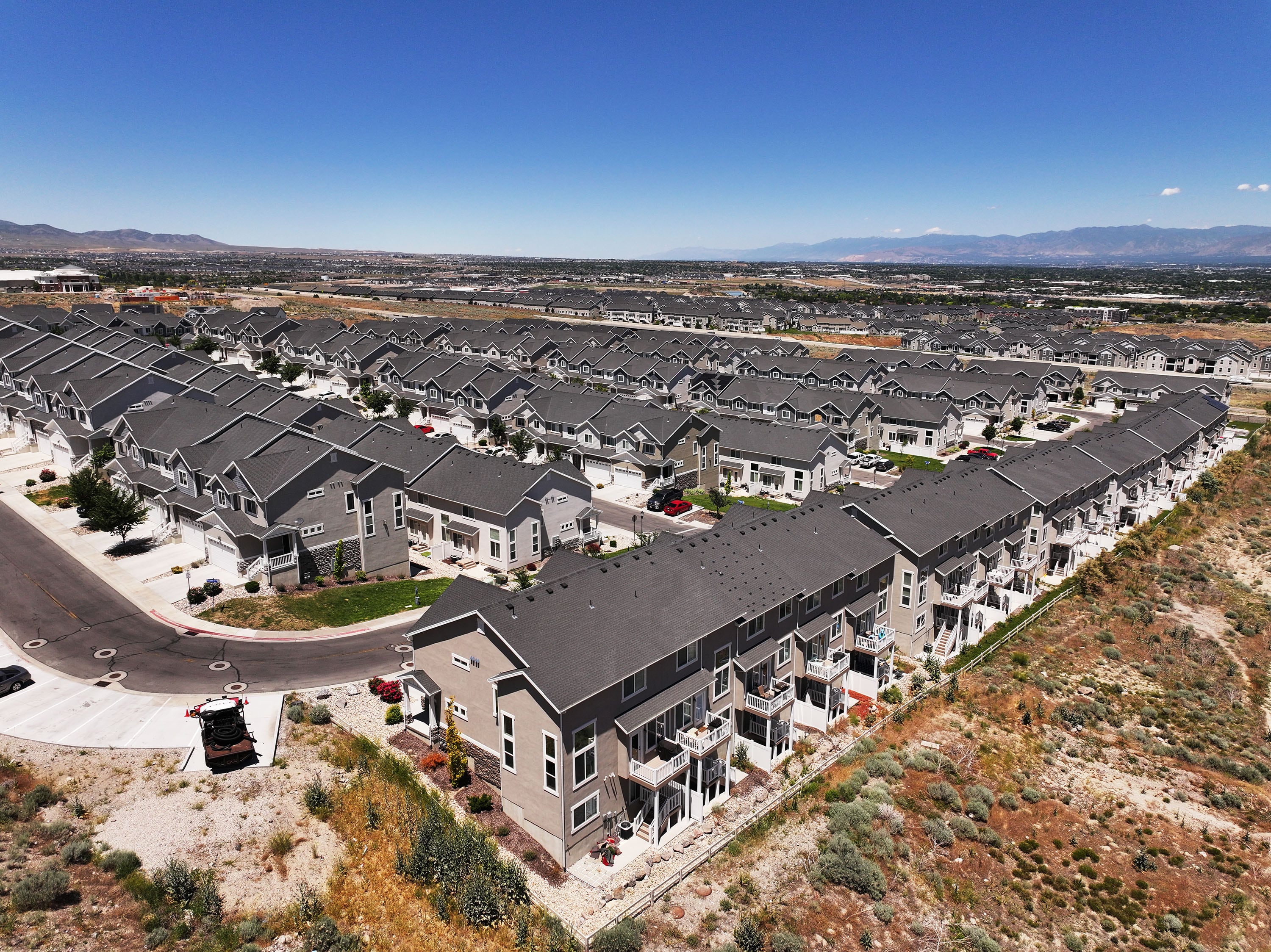 Homes and "For sale" signs are pictured in the Salt Lake Valley on June 18. A new report by WalletHub found that Utah is ranked the most financially independent state.