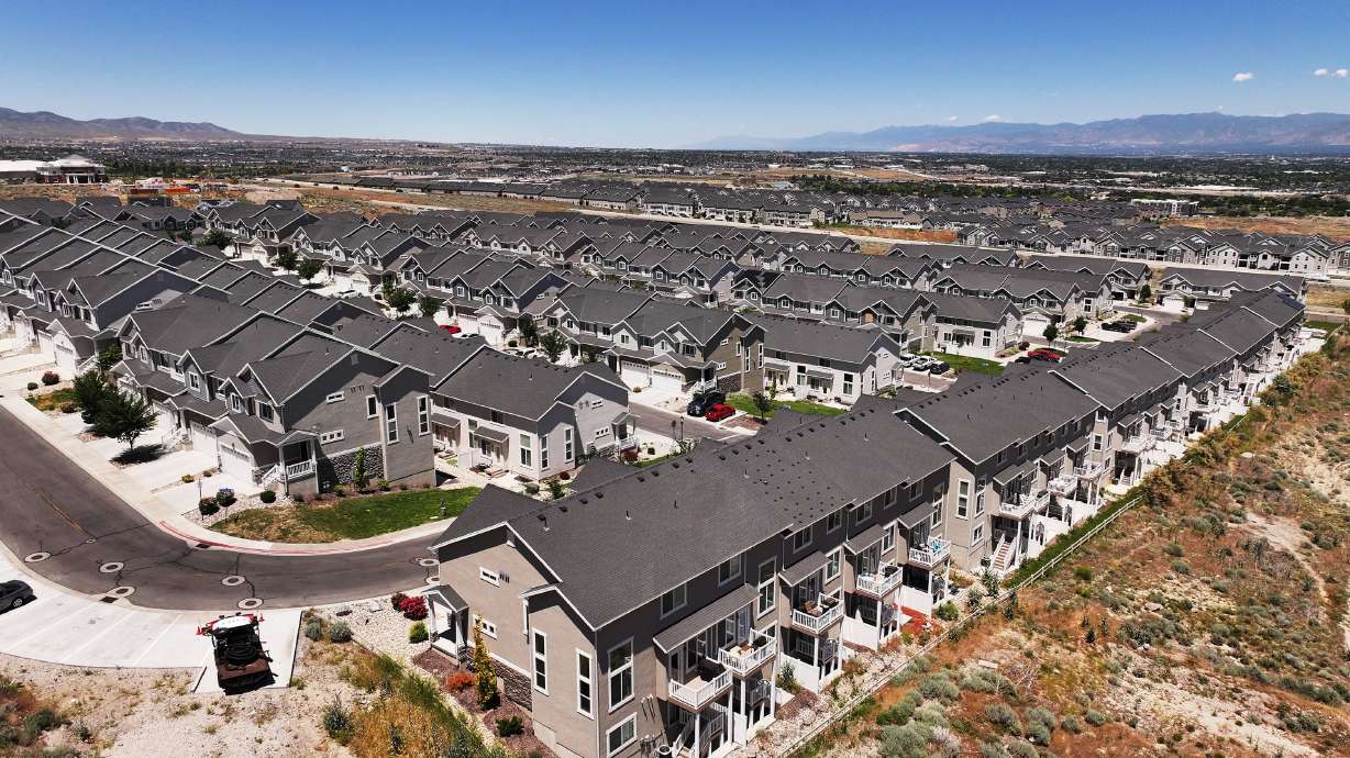Homes and "For sale" signs are pictured in the Salt Lake Valley on June 18. A new report by WalletHub found that Utah is ranked the most financially independent state.