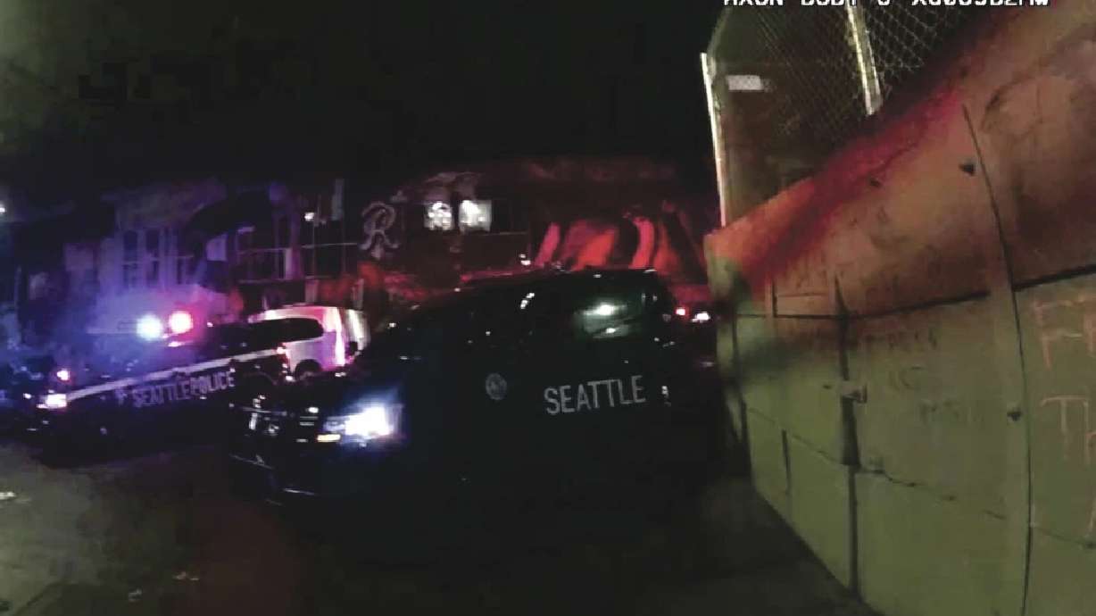 Anti-police graffiti was written in chalk on a concrete barricade near a Seattle police precinct, Jan. 1, 2021, in Seattle. Four protestors who were jailed for the graffiti were awarded nearly $700,000 by a federal jury who decided their civil rights had been violated.