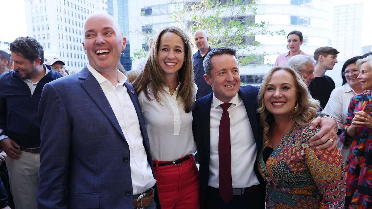 Gov. Spencer Cox and first lady Abby Cox and Derek Brown and his wife Emilie Brown greet supporters during the election night party in Salt Lake City on Tuesday.