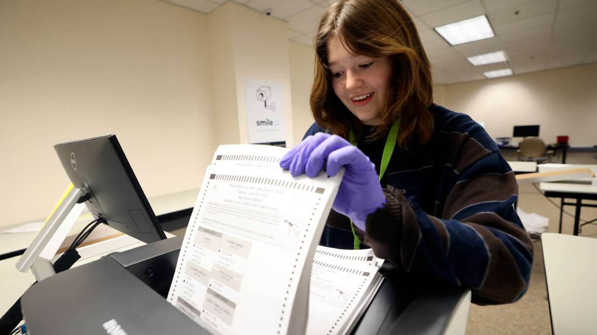 Maggie Brunner, temporary election worker, scans ballots at the Salt Lake County Government Center in Salt Lake City on June 26. The U.S. is facing a shortage of poll workers with fewer than 100 days before the November general election.