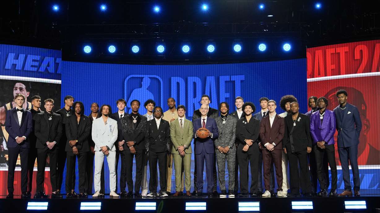 NBA commissioner Adam Silver, center, poses for a photo with some of the potential first-round selections before the NBA basketball draft, Wednesday, June 26, 2024, in New York.