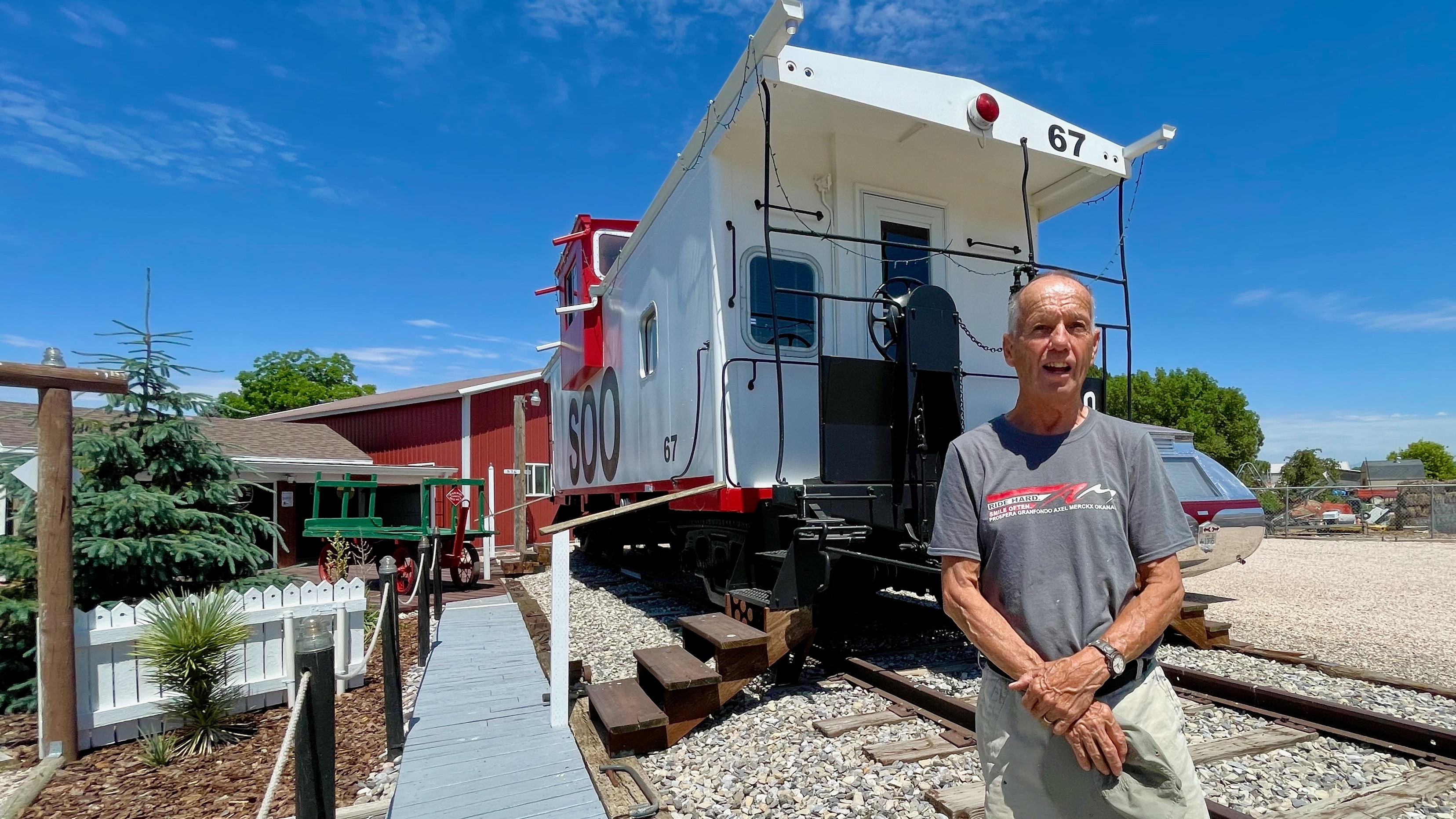 Michael Ackley stands outside a caboose transplanted to Ackley Western Town, the Old West museum he built on the grounds of his home in Taylor. The photo was taken Tuesday, June 25, 2024.