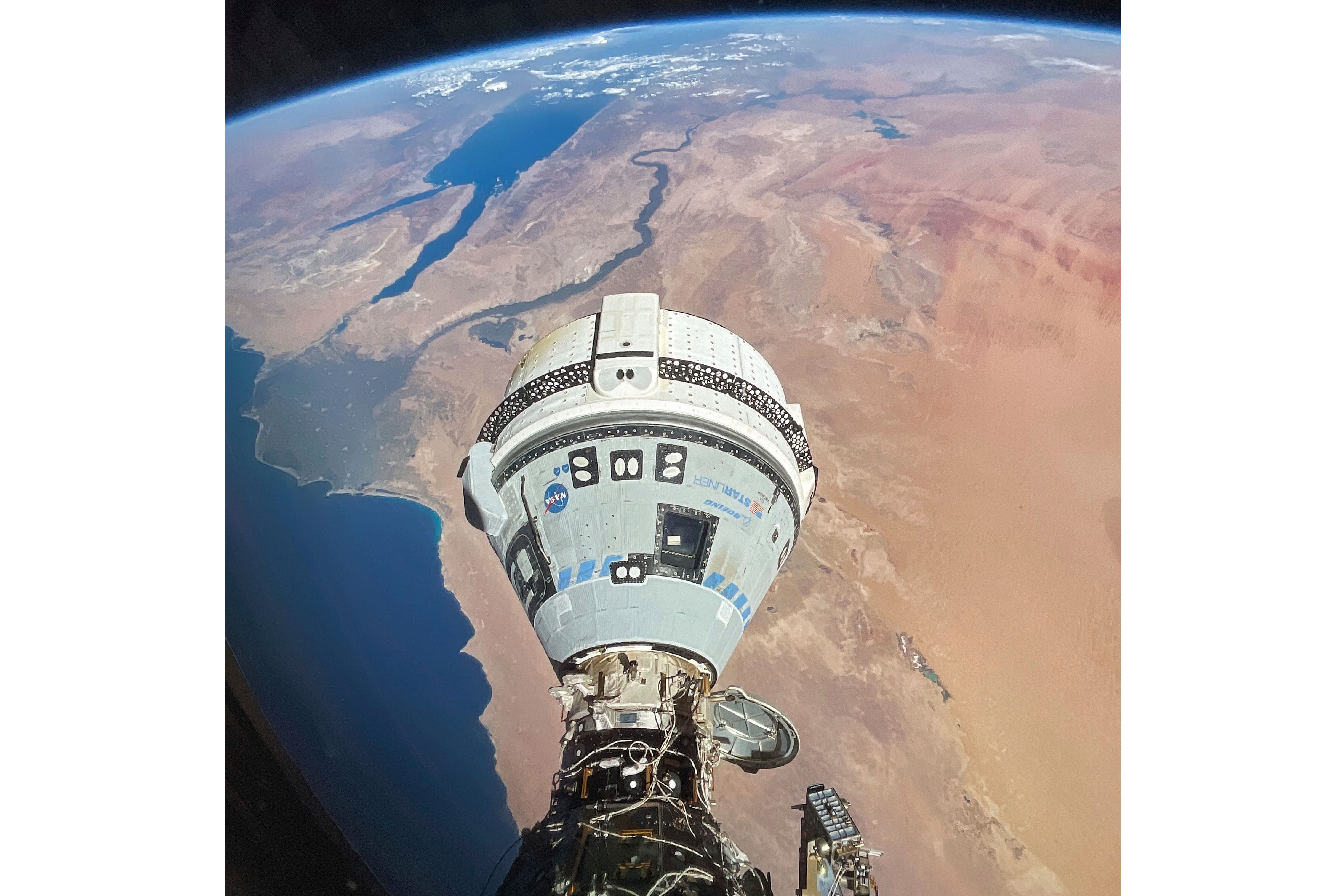 This photo provided by NASA shows the Starliner spacecraft docked to the Harmony module of the International Space Station, orbiting 262 miles above Egypt's Mediterranean coast, on June 13. NASA representatives said the capsule and its two-person crew are weeks away from returning to Earth.