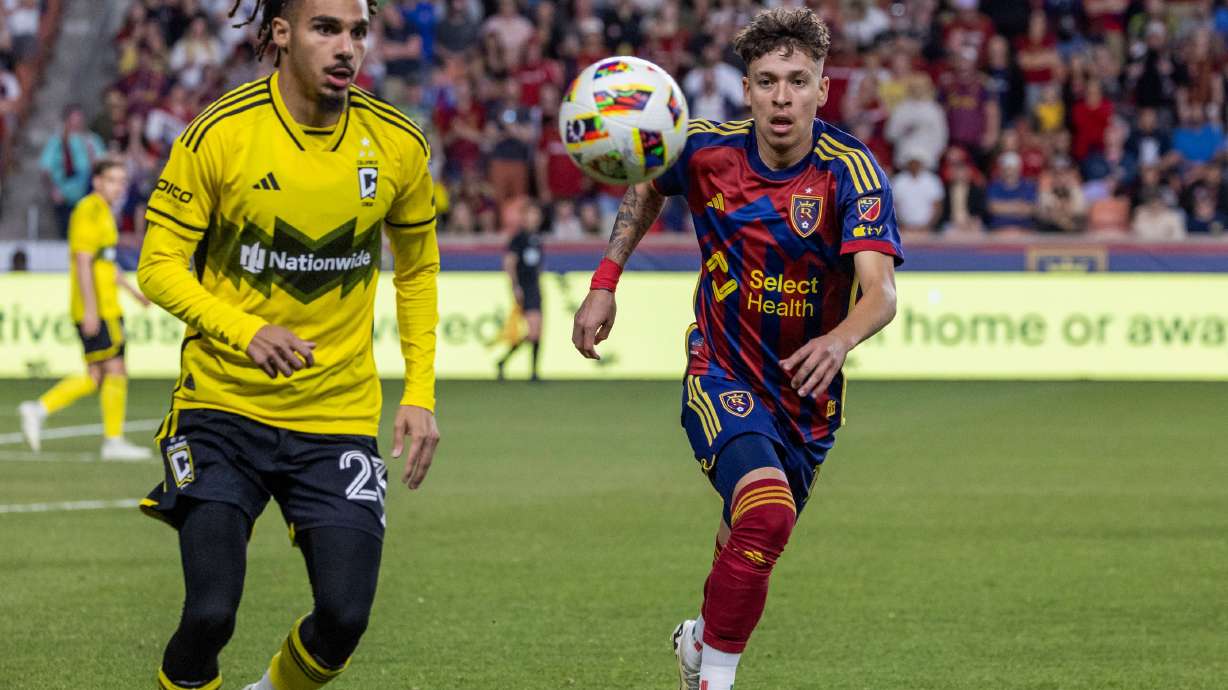Real Salt Lake forward Fidel Barajas, right, and Columbus Crew defender Mohamed Farsi, left, run for the ball during a Major League Soccer game at the America First Field in Sandy on Saturday, April 13, 2024.