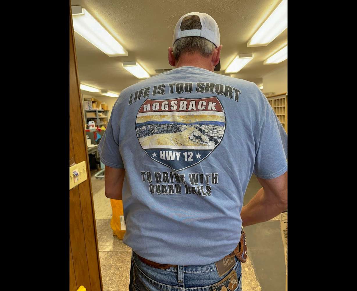 Garfield County mailman Tracy Sidwell's "work" T-shirt celebrates the fabled Highway 12 hogsback.