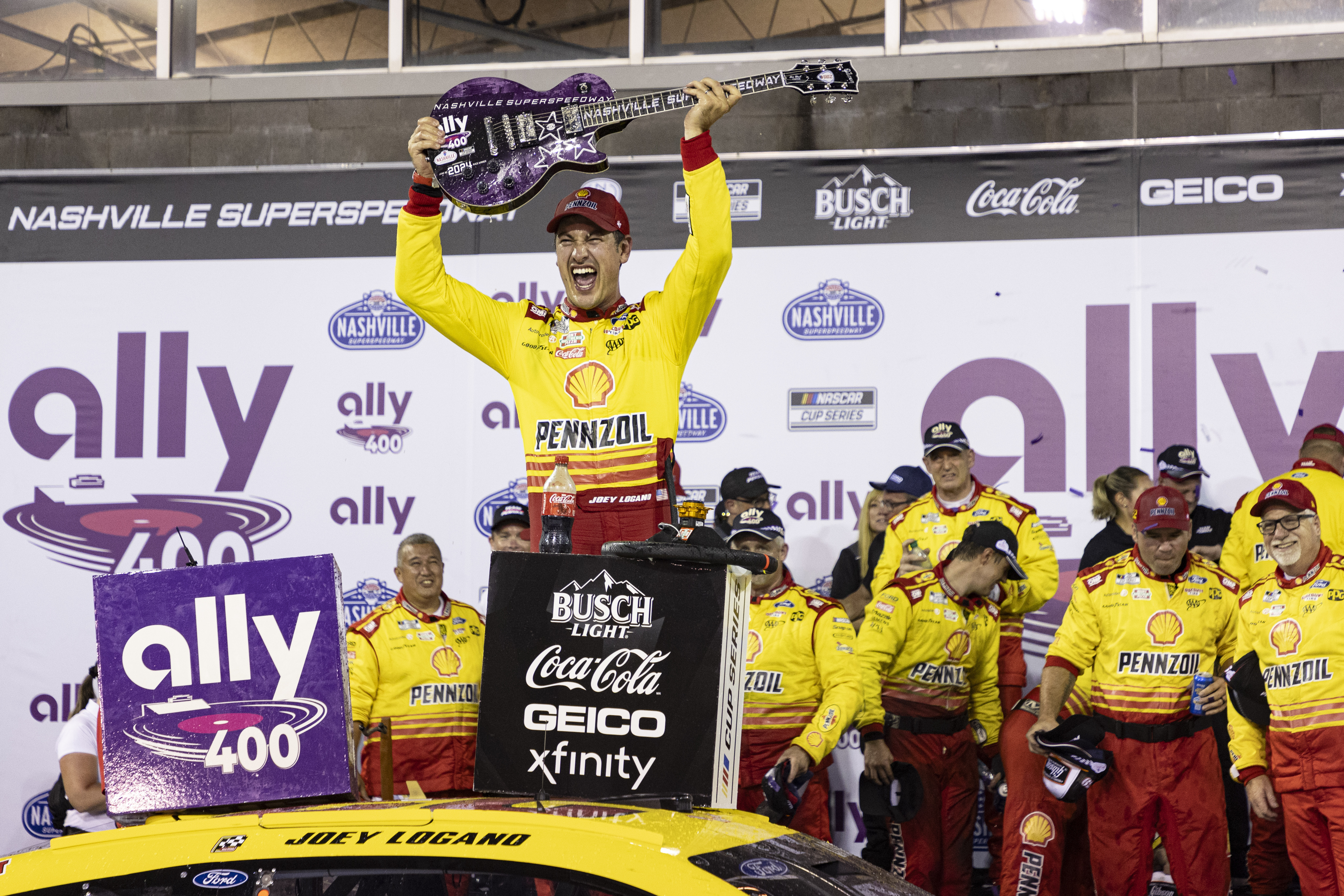 Joey Logano, top, celebrates after winning a NASCAR Cup Series auto race, Sunday, June 30, 2024, in Gladeville, Tenn. 