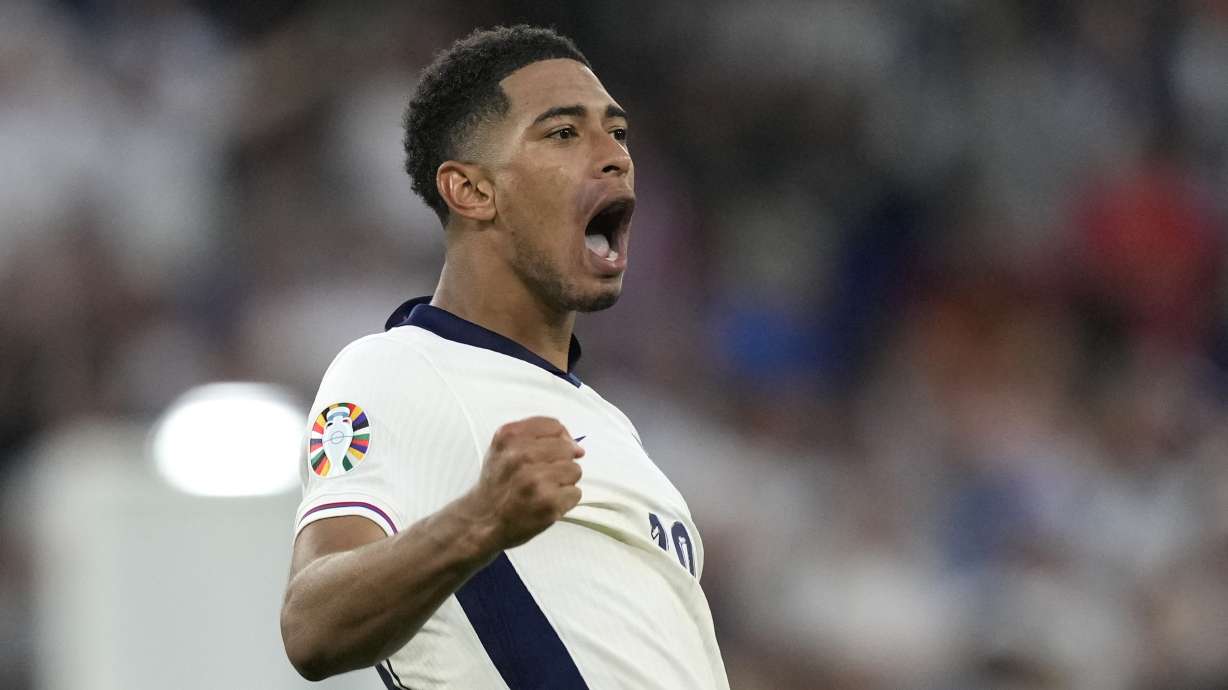 England's Jude Bellingham celebrates at the end of the round of sixteen match between England and Slovakia at the Euro 2024 soccer tournament in Gelsenkirchen, Germany, Sunday, June 30, 2024.