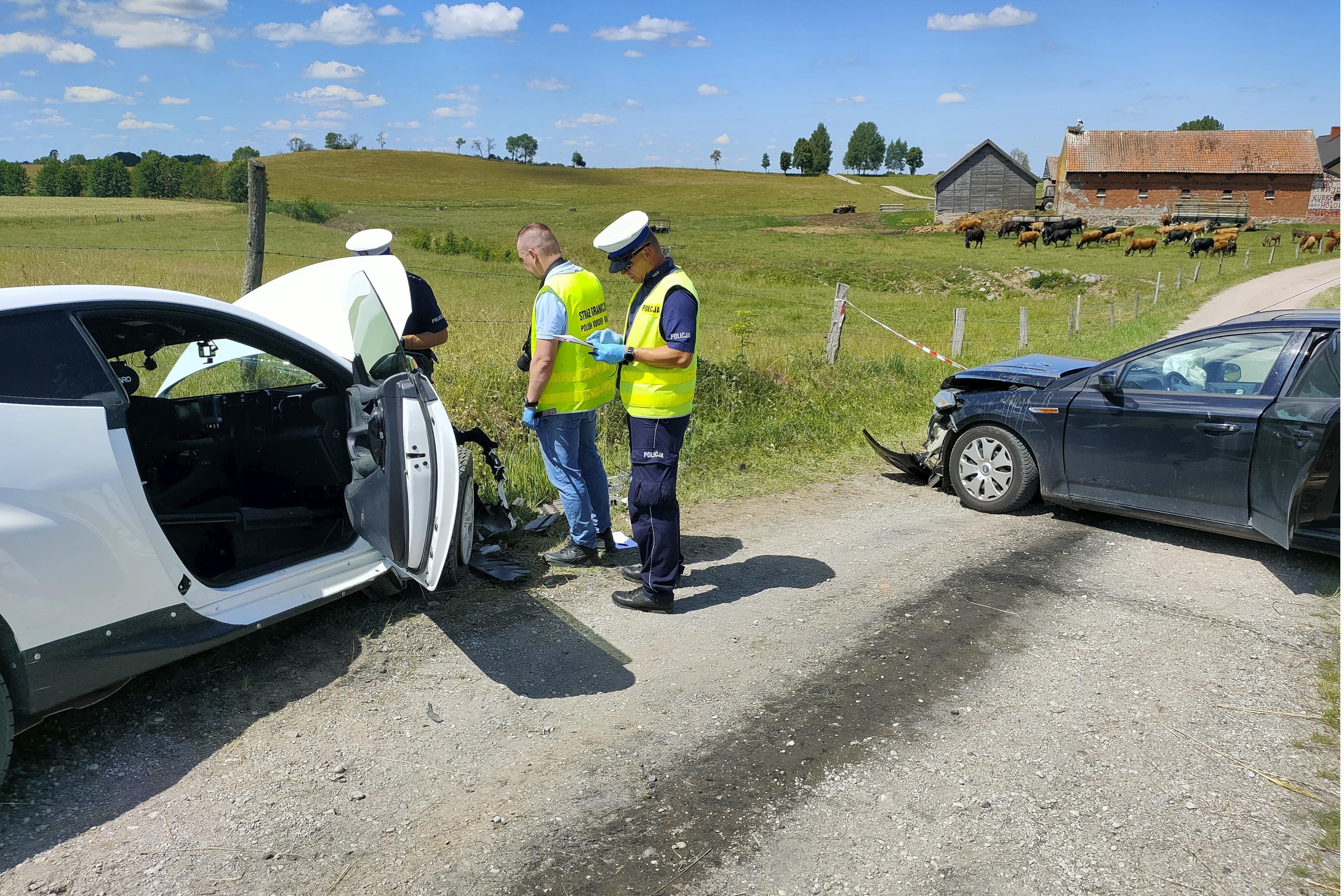 Police officers are investigating the site of a crash between the white Toyota of eight-time world rally champion Sebastien Ogier and co-driver Vincent Landais, left, and a local resident's Ford, right, that collided head-on on a local road near the village of Wlosty, near Goldap in northeastern Poland, Tuesday, June 25, 2024, while the Ogier and Landais were on a reconnaissance run ahead of this week's Rally Poland. Ogier and the Ford's driver were airlifted to hospital while Landais and the Ford's female passenger were taken by ambulances. 