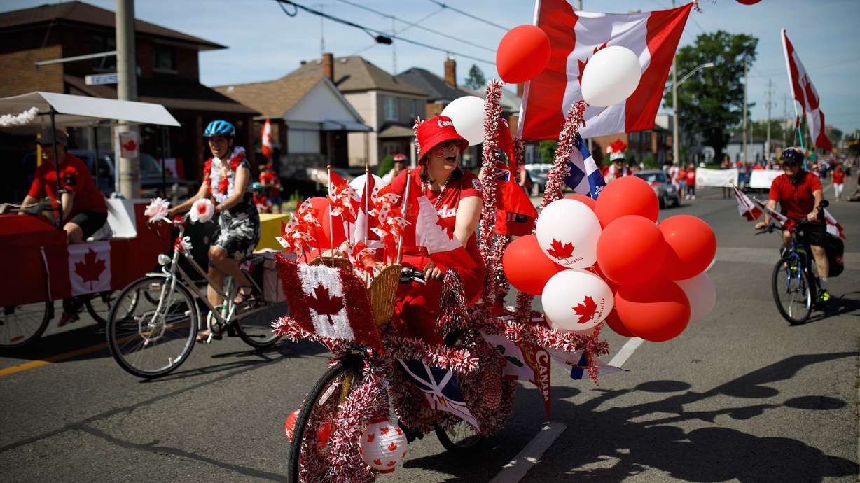 A cyclist rides in the East York Canada Day Parade in July 2019 in Toronto, Canada. Canada pays tribute to its own origin story three days before U.S. celebrates Independence Day.