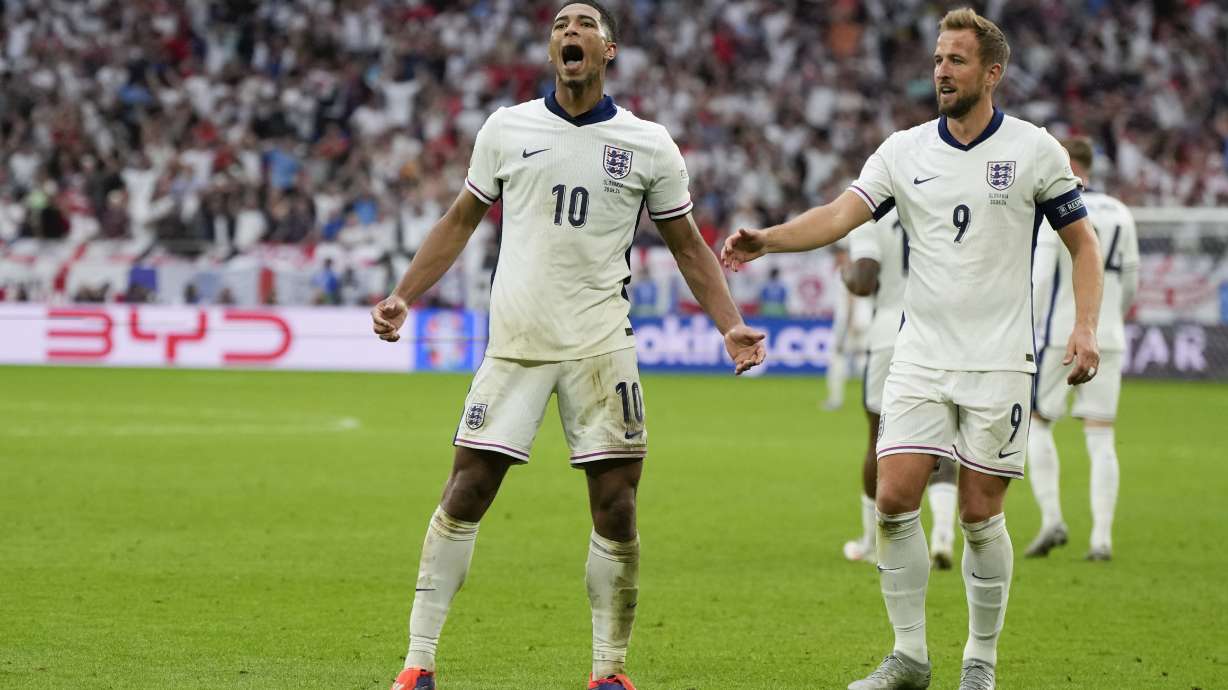 England's Jude Bellingham (10) celebrates with Harry Kane after scoring during a round of sixteen match between England and Slovakia at the Euro 2024 soccer tournament in Gelsenkirchen, Germany, Sunday, June 30, 2024.