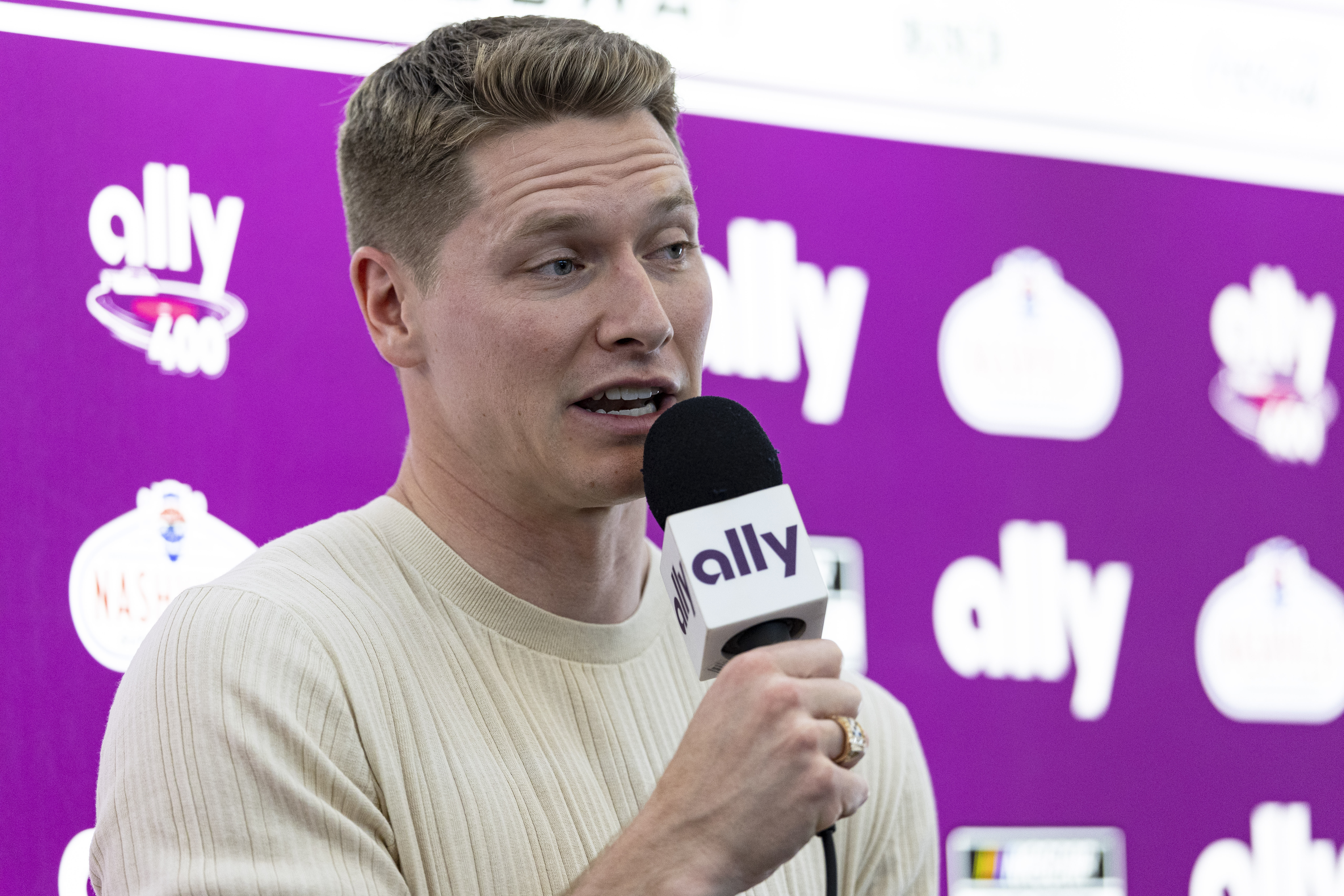 Two-time Indianapolis 500 winner Josef Newgarden speaks to reporters before a NASCAR Cup Series auto race, Sunday, June 30, 2024, in Gladeville, Tenn.