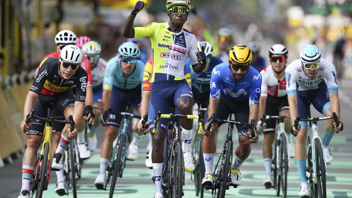 Eritrea's Biniam Girmay celebrates winning ahead of Belgium's Arnaud de Lie, left, and Colombia's Fernado Gavira, center right, during the third stage of the Tour de France cycling race over 230.8 kilometers (143.4 miles) with start in Piacenza and finish in Turin, Italy, Monday, July 1, 2024.