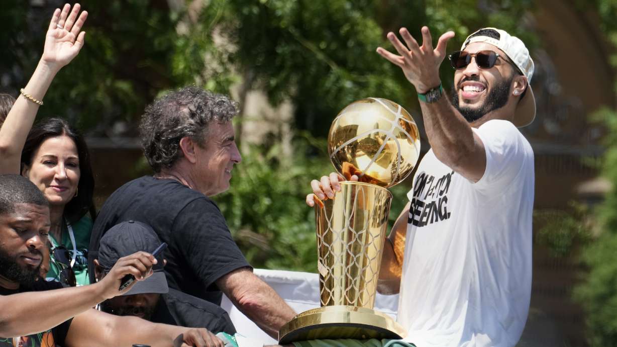 Boston Celtics' Jayson Tatum, right, and Celtics owner Wyc Grousbeck, center, celebrate their NBA basketball championship with a duck boat parade Friday, June 21, 2024, in Boston.
