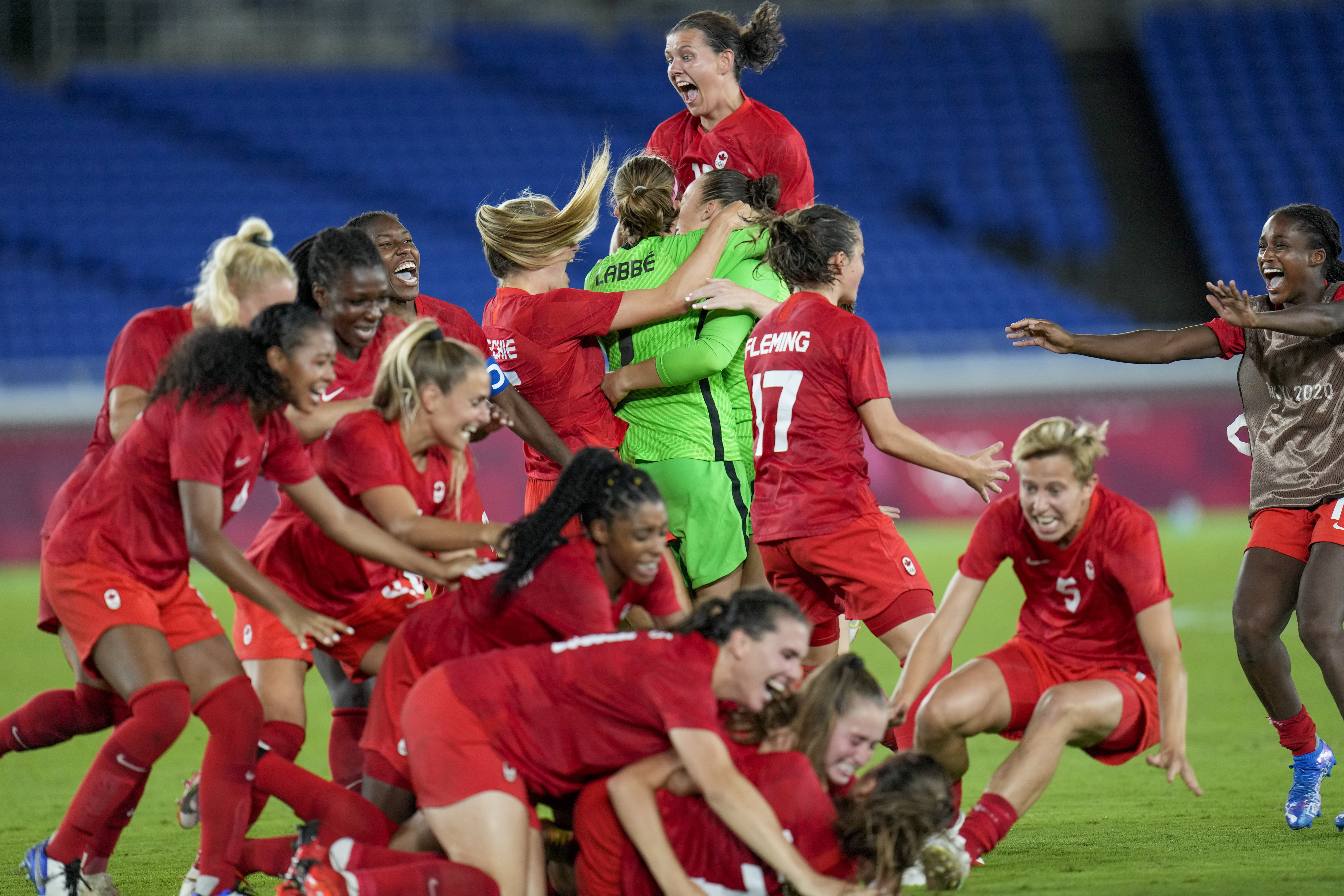 FILE - Canada player celebrate defeating Sweden for the gold medal in women's soccer at the Summer Olympics, Aug. 6, 2021, in Yokohama, Japan. Defending Olympic gold medalist Canada is looking to re-establish itself following last year’s Women’s World Cup disappointment. 