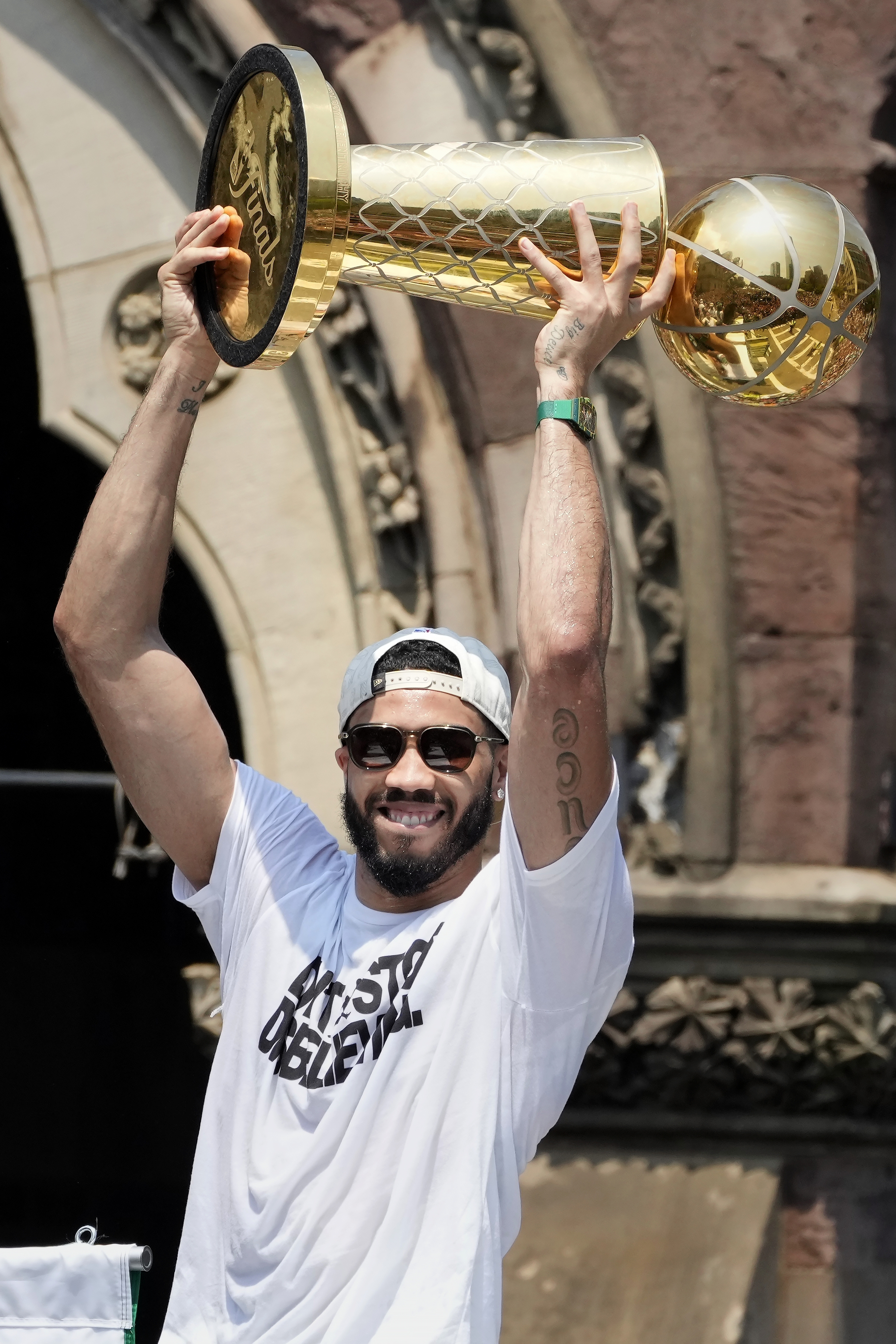 Boston Celtics' Jayson Tatum celebrates the team's NBA basketball championship during a duck boat parade Friday, June 21, 2024, in Boston.