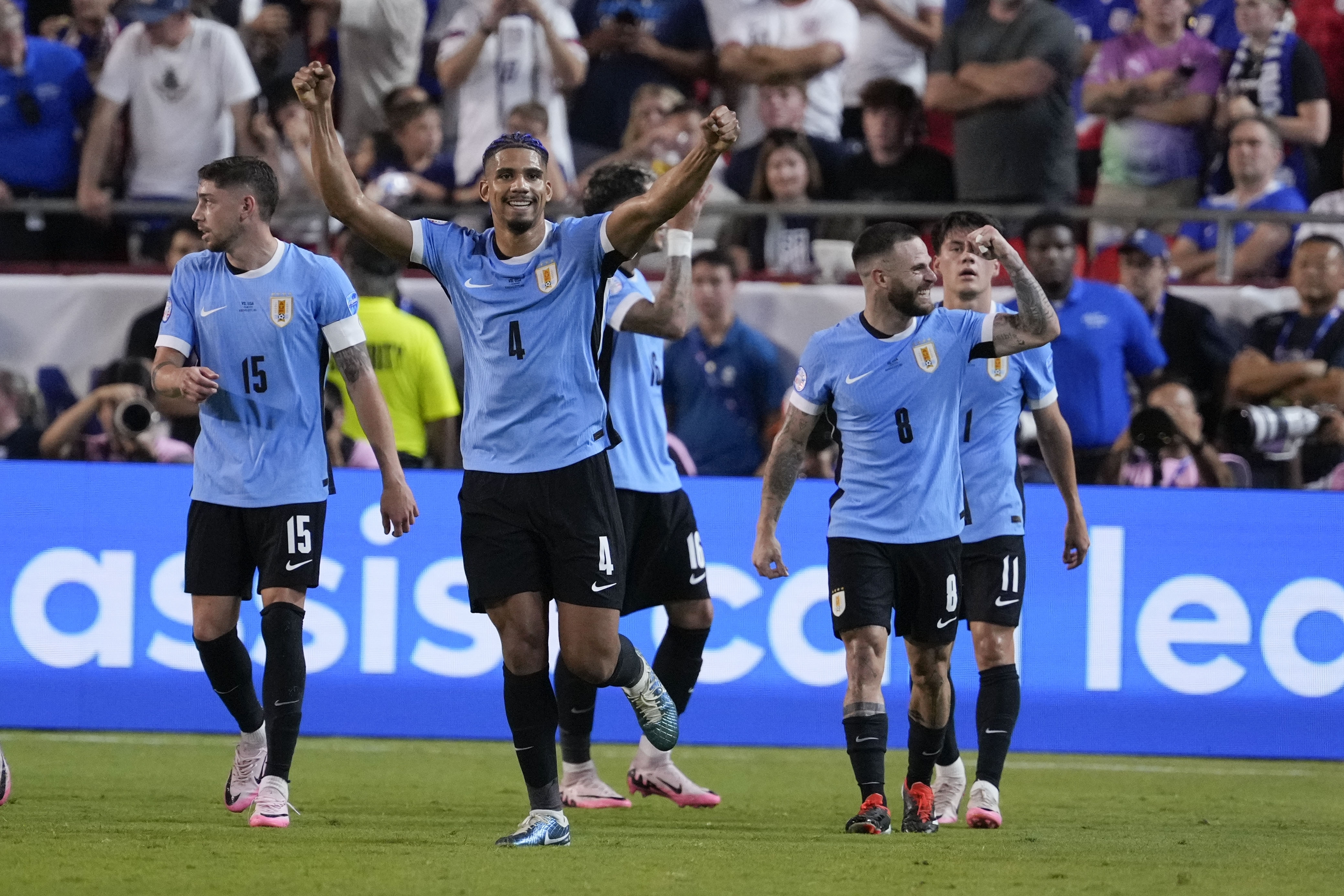 Uruguay's Ronald Araujo (4) celebrates after a goal by Mathias Olivera during a Copa America Group C soccer match against the United States, Monday, July 1, 2024, in Kansas City, Mo. 