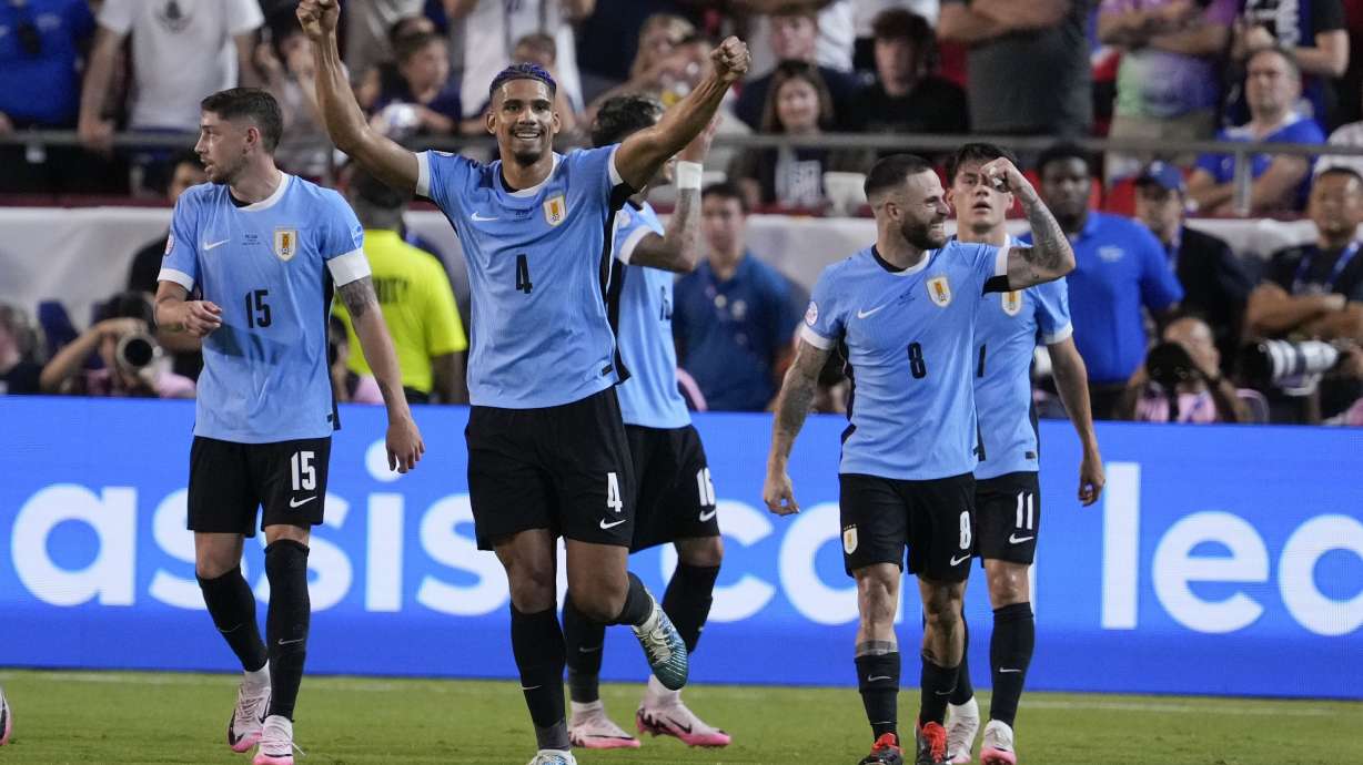Uruguay's Ronald Araujo (4) celebrates after a goal by Mathias Olivera during a Copa America Group C soccer match against the United States, Monday, July 1, 2024, in Kansas City, Mo.